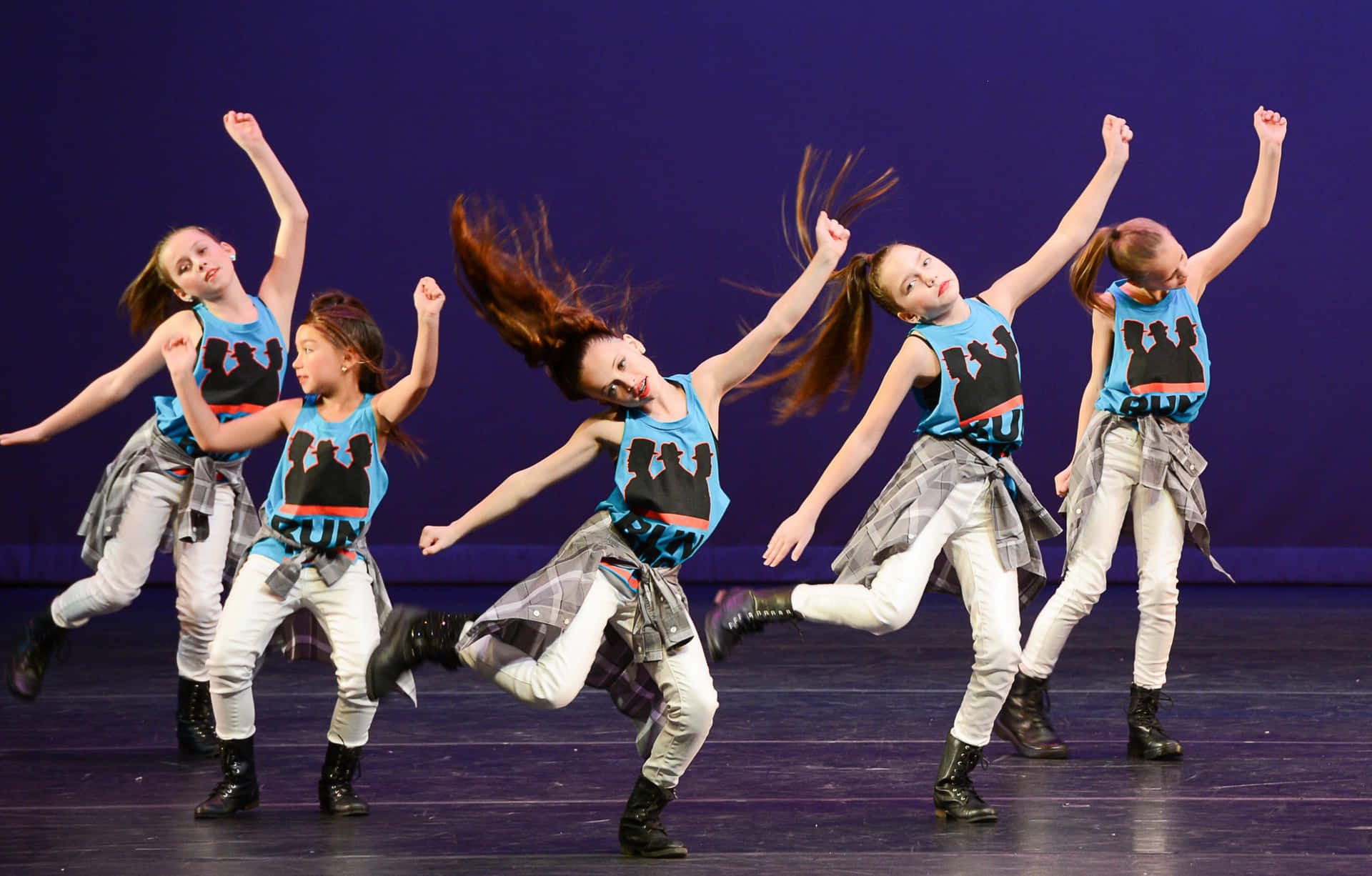 A Group Of Young Girls Performing On Stage