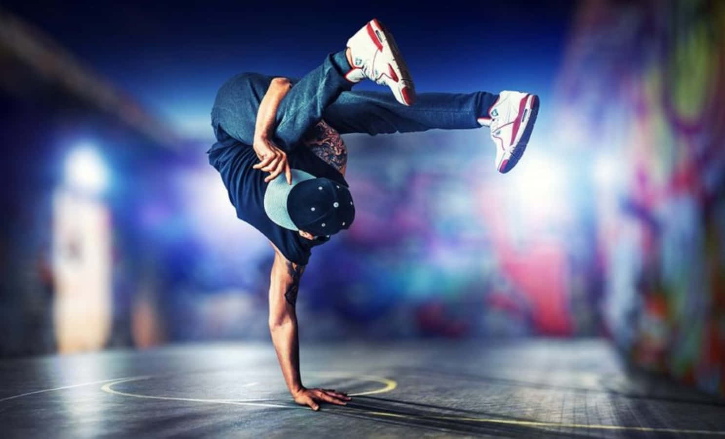 A Man Doing A Handstand In A Dark Area