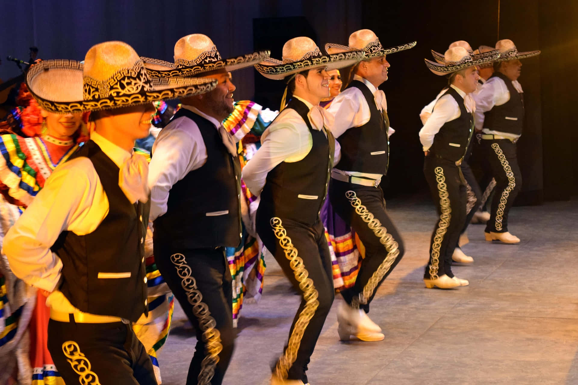 Mexican Dancers In Traditional Clothing Perform On Stage Wallpaper