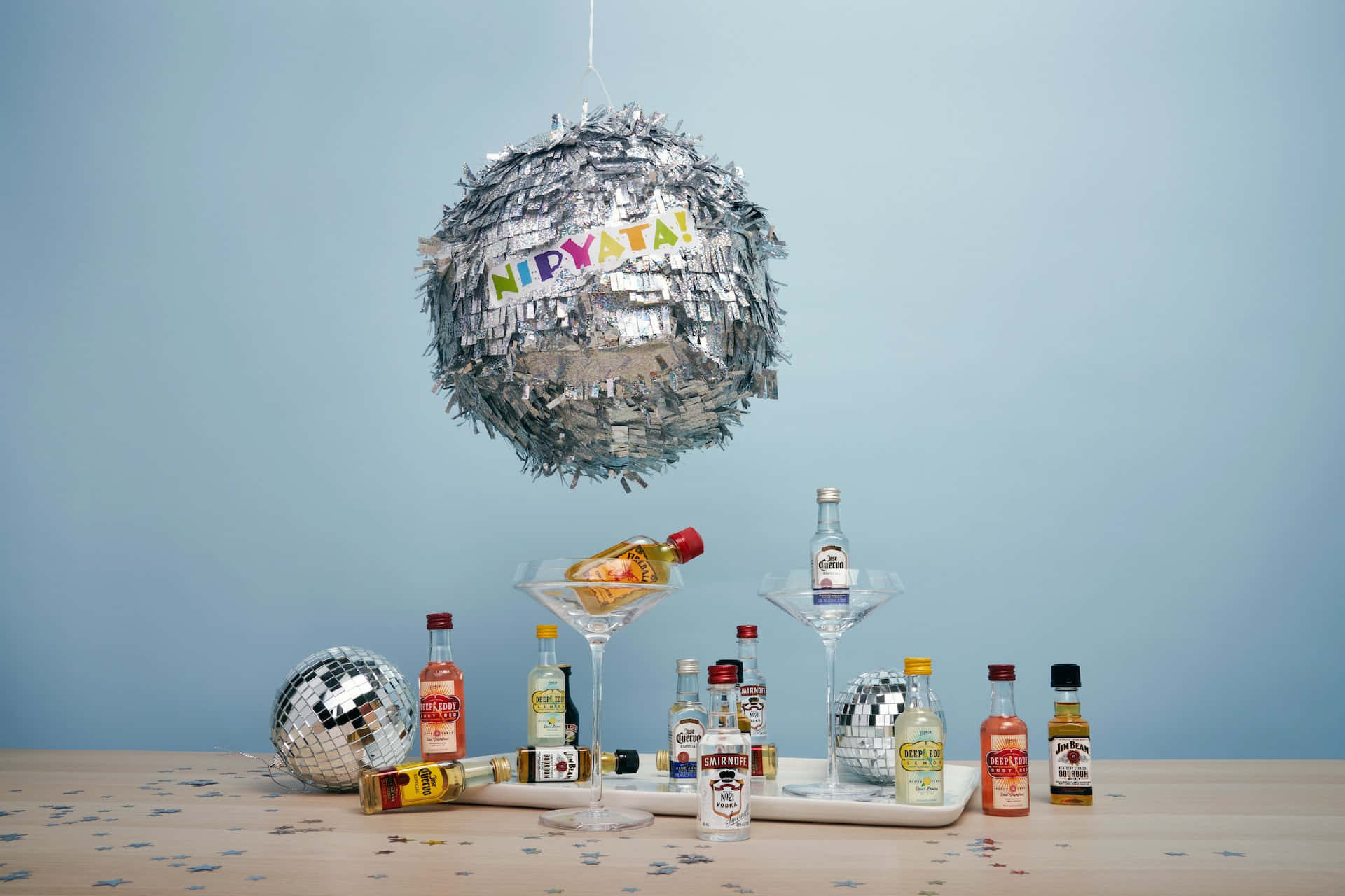 A Table With A Pinata Hanging From It And A Bottle Of Liquor Wallpaper