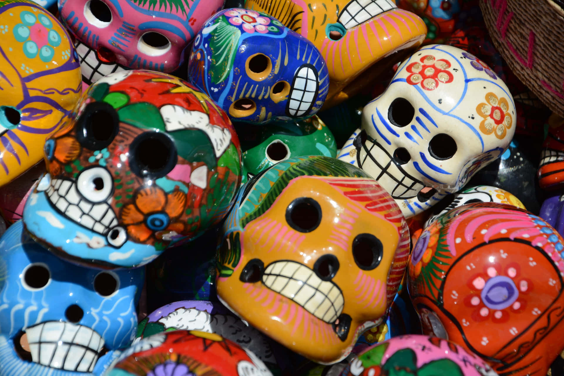 Colorful Sugar Skulls Are Arranged In A Basket Wallpaper