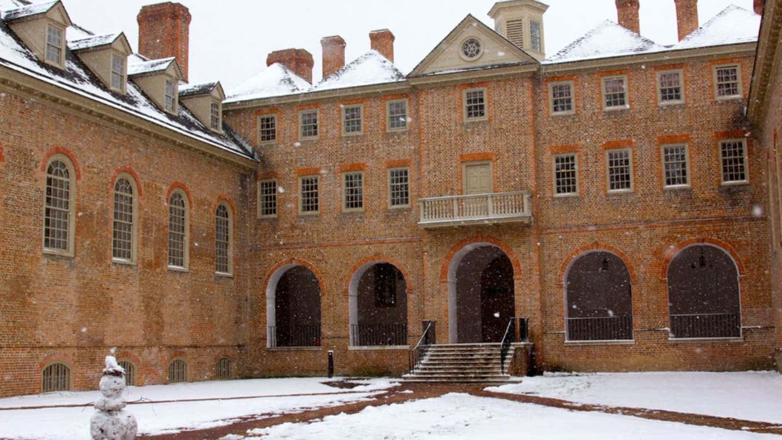 Historic College Buildingin Snow Wallpaper