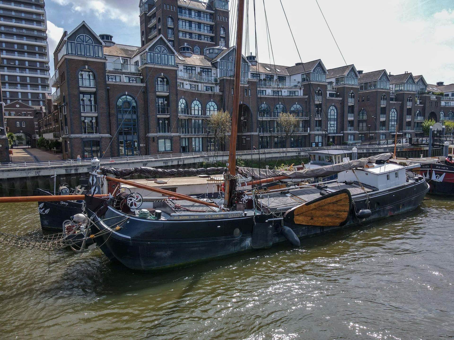 Historic Sailboat Against Urban Backdrop Lelystad Wallpaper