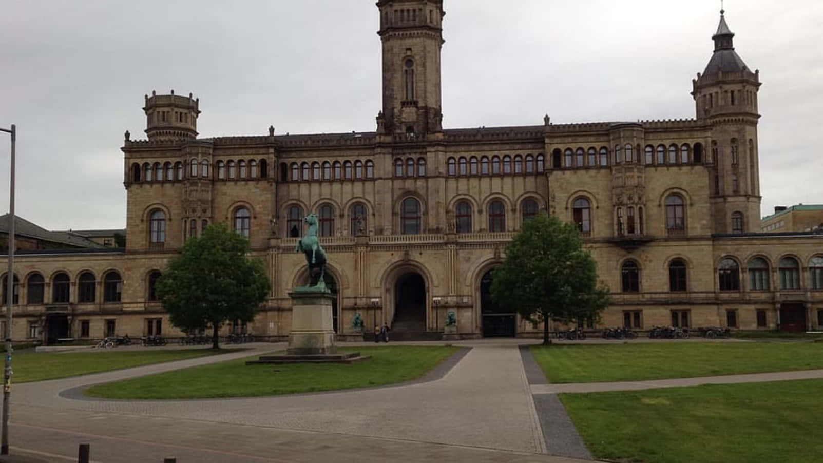 Historic University Buildingwith Statue Wallpaper