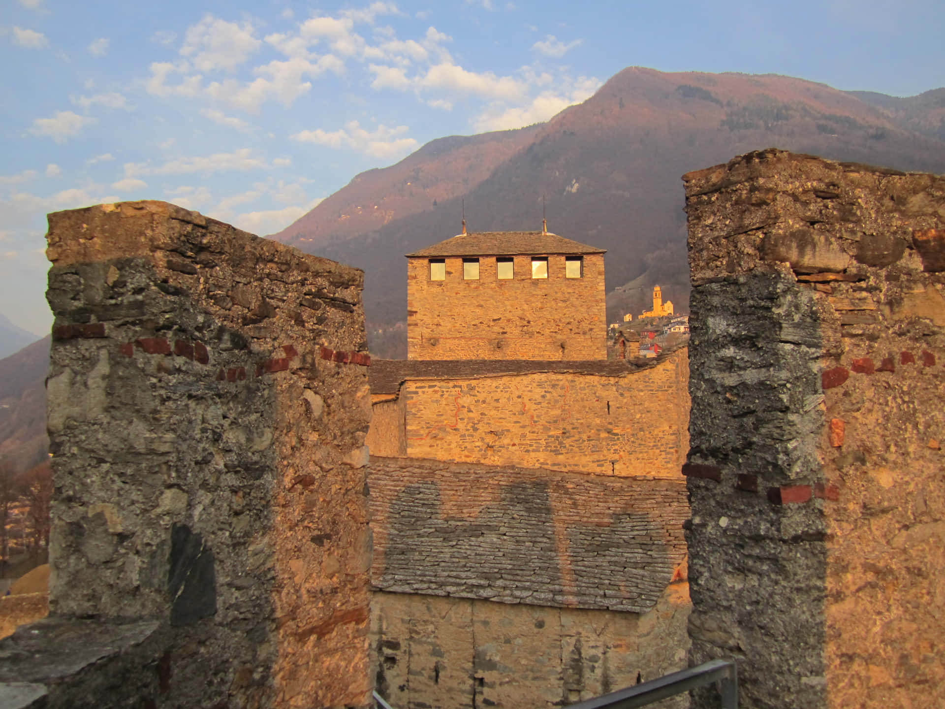 Historical Bellinzona Castle Against The Backdrop Of Majestic Swiss Alps Wallpaper