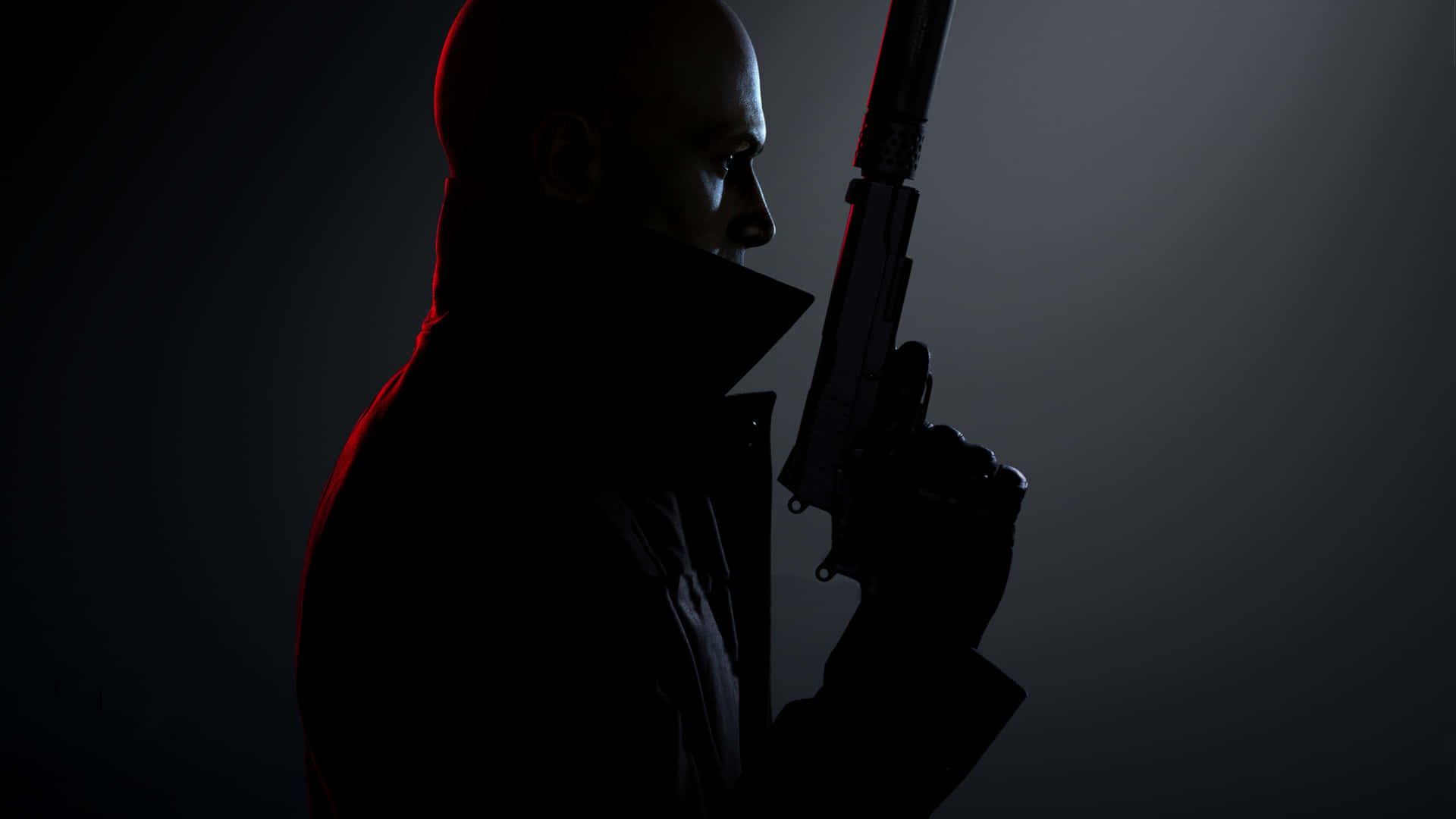 Agent 47 sneaking through the shadows in Hitman 3 Wallpaper