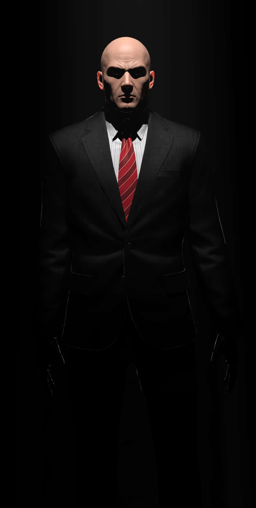 En mand i jakkesæt og slips står i mørket Wallpaper