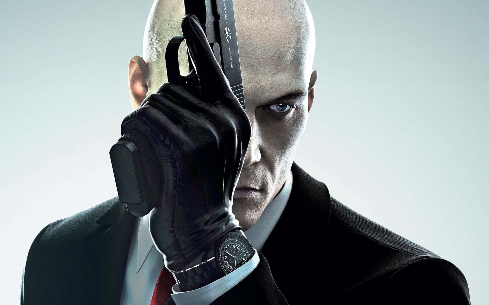 Hitman Agent 47 Covering Face With Gun Wallpaper