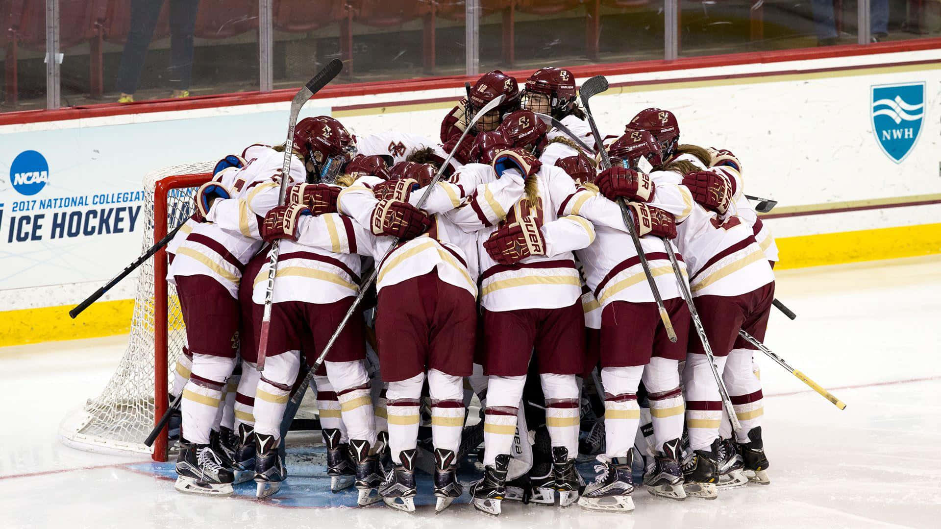 A Group Of Hockey Players Huddle Together On The Ice