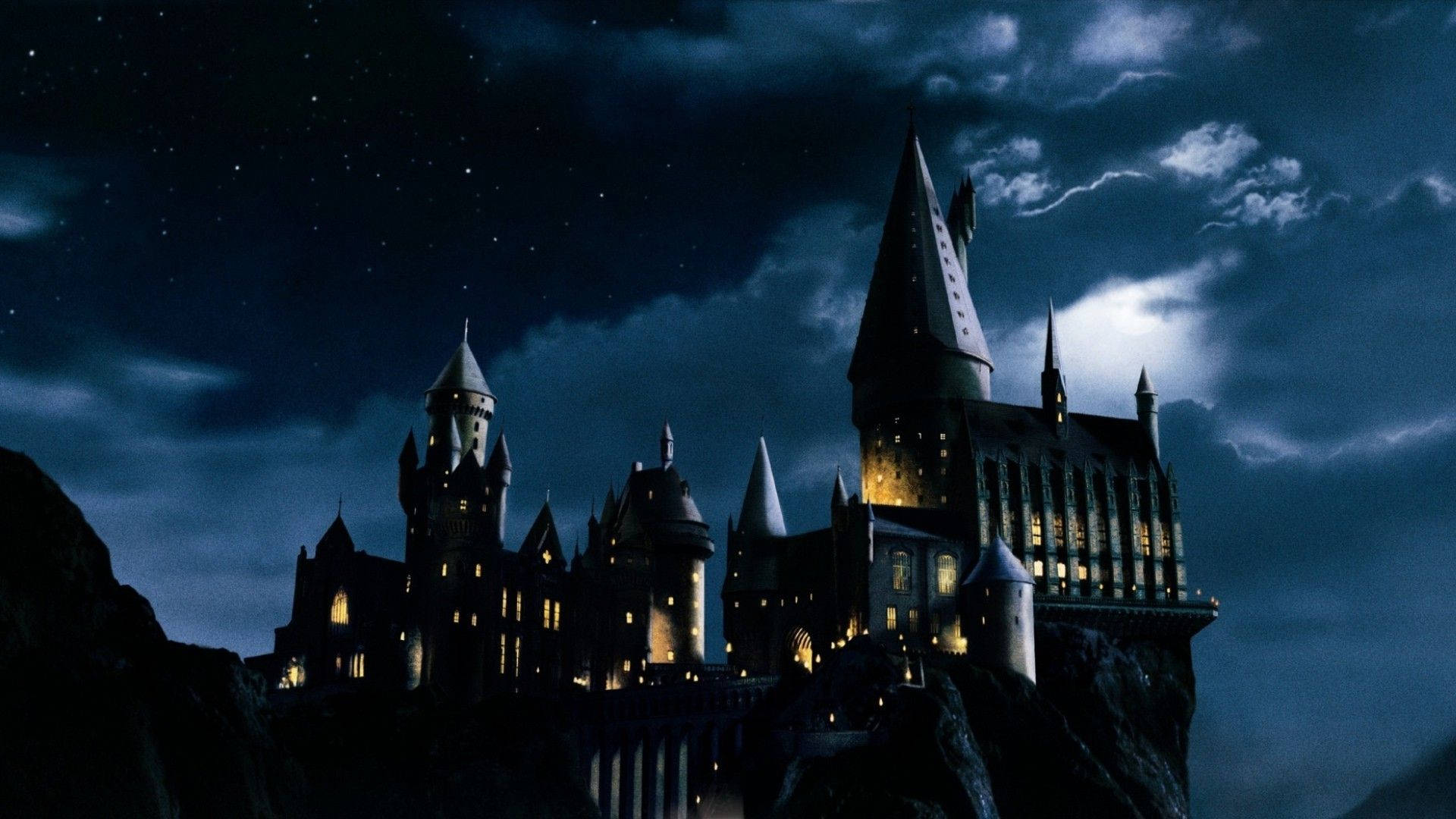 The Iconic Skyline of Hogwarts Castle at Night Wallpaper
