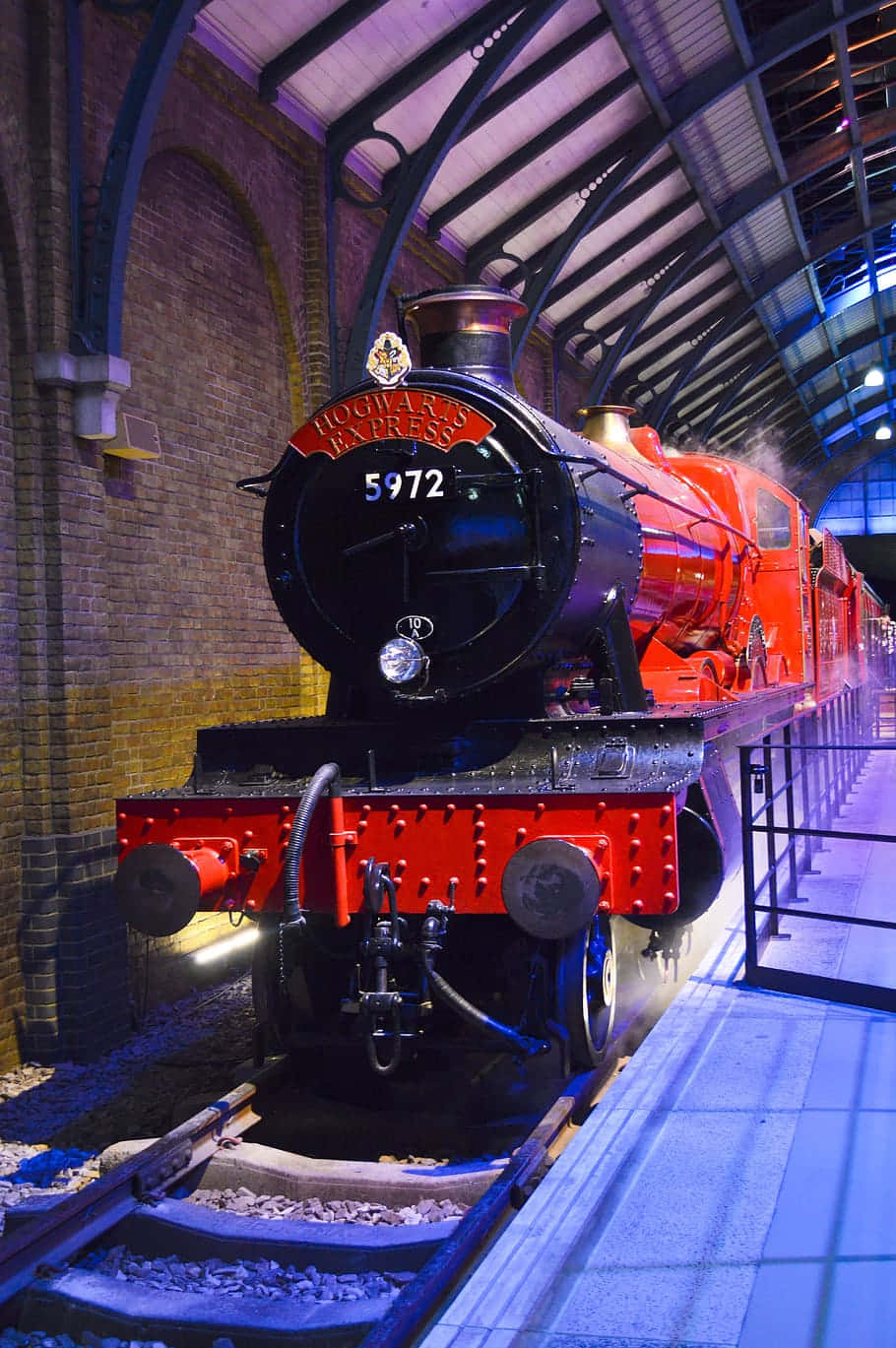 The iconic Hogwarts Express steams through the countryside on its way to the magical school. Wallpaper