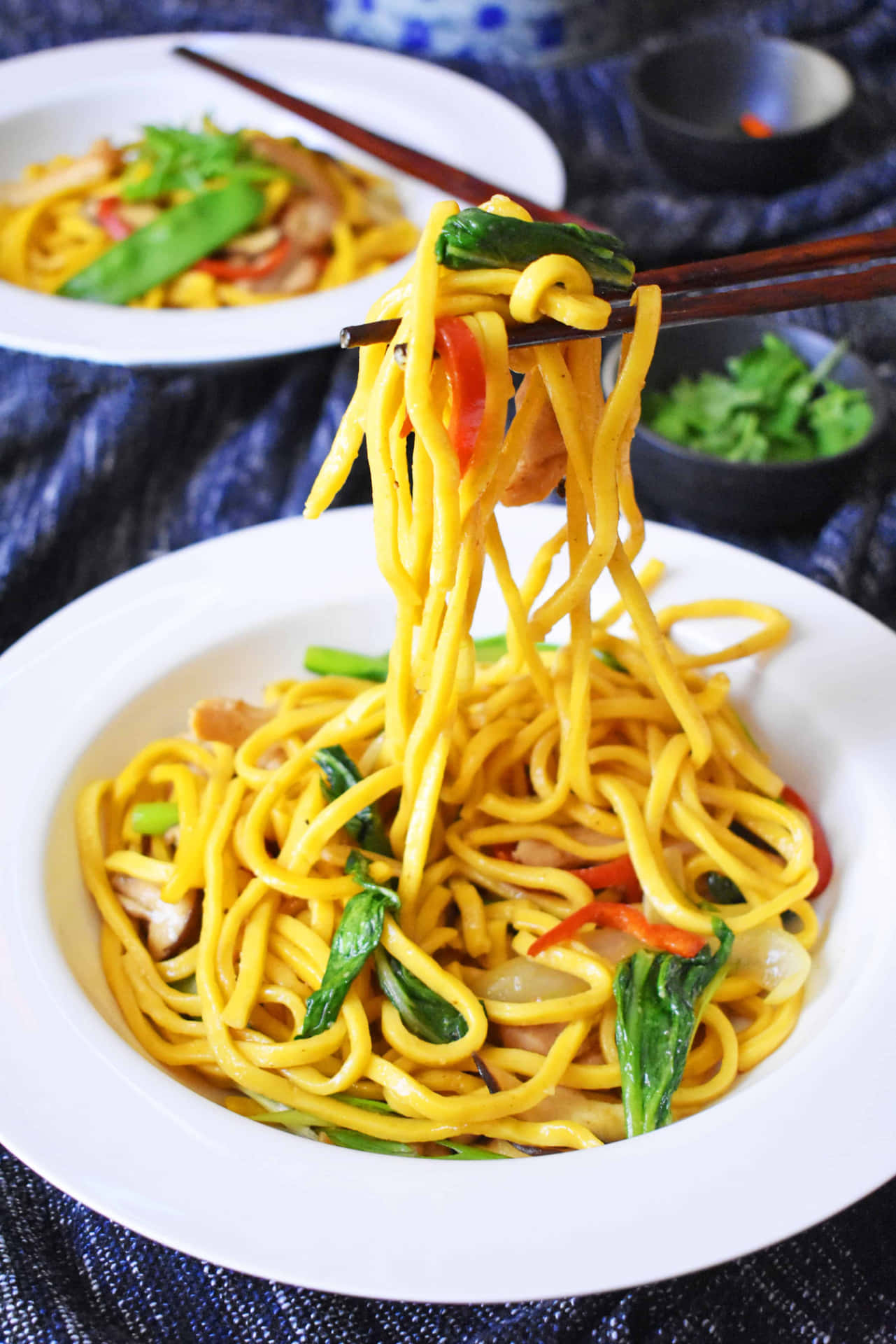 Delectable stir-fried Hokkien Mee showcasing a mix of vibrant ingredients Wallpaper