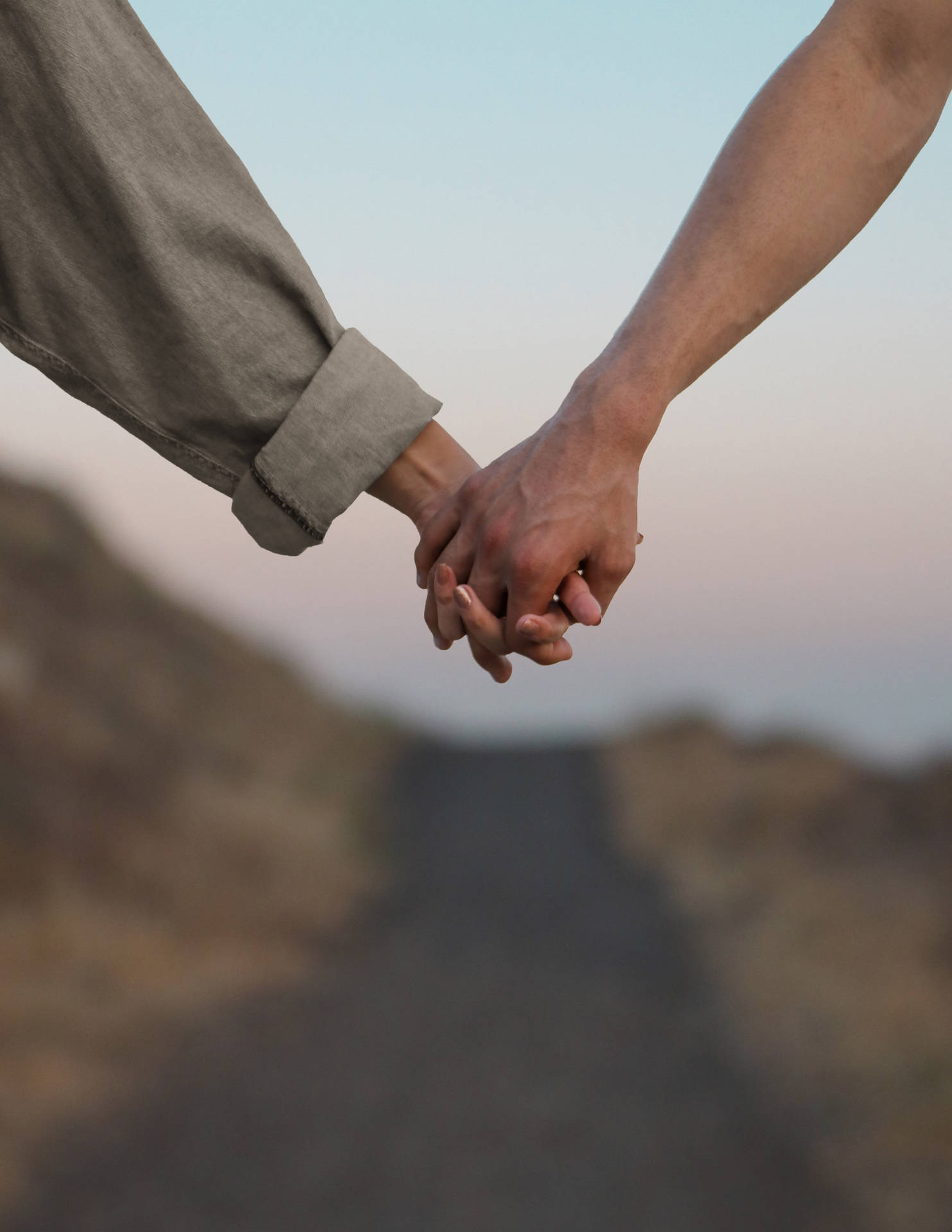 Holding Hands On A Deserted Road Wallpaper