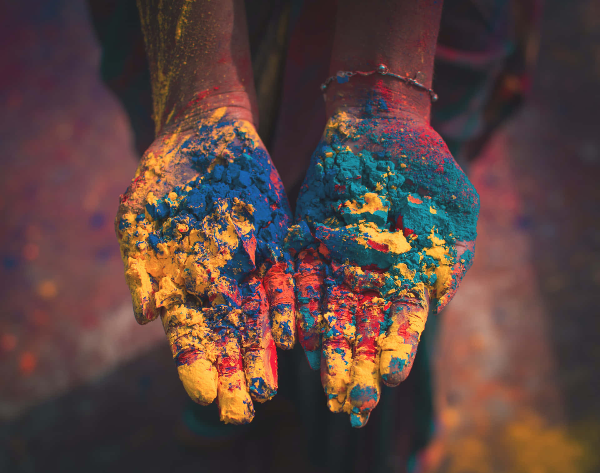 holi festival - woman's hands covered in colored powder