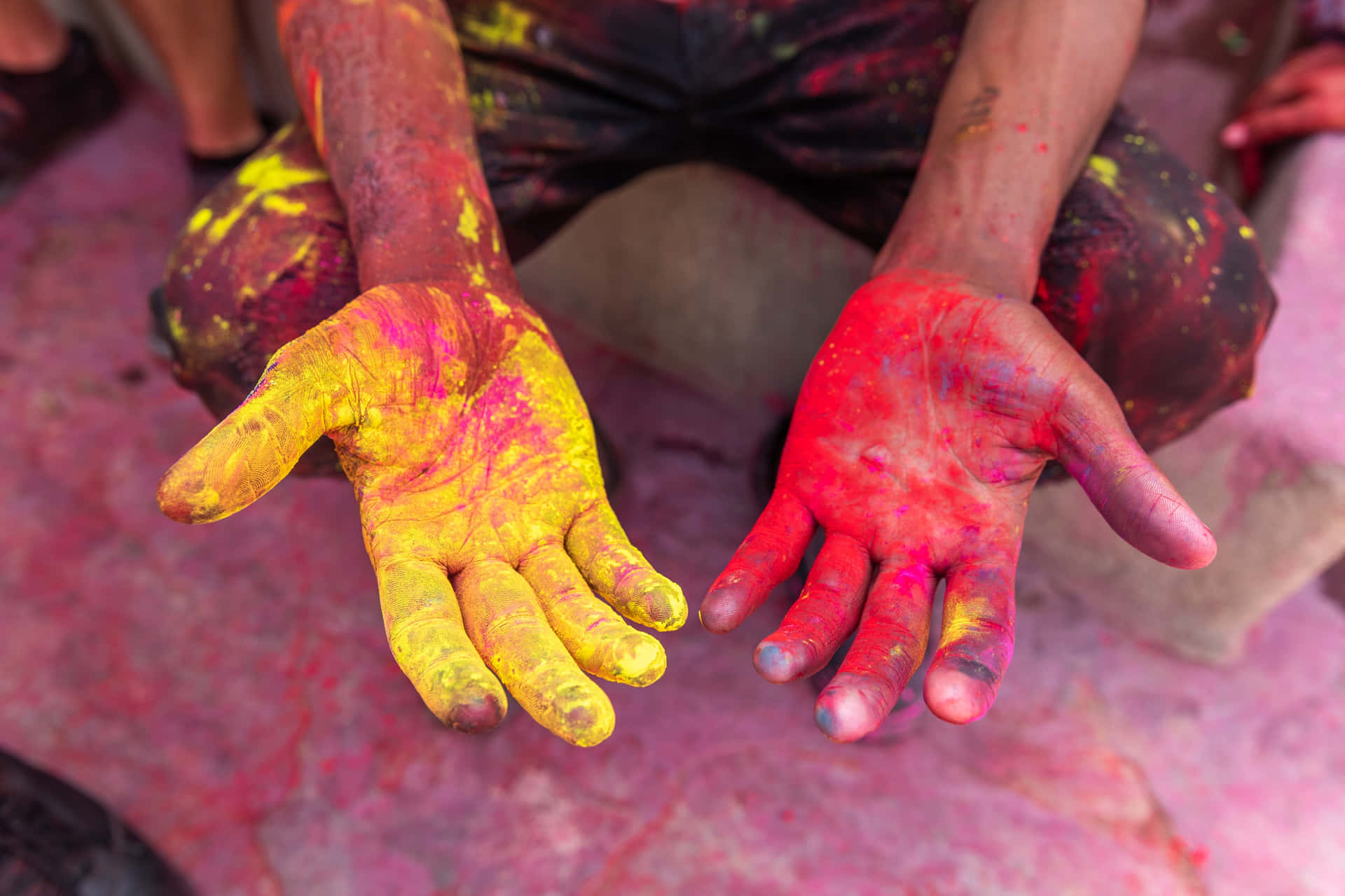a man with his hands painted with colorful paint