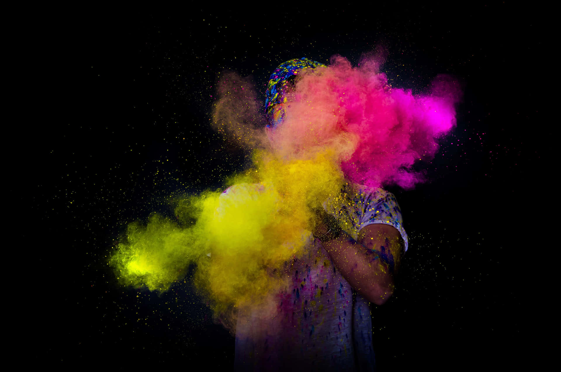 a man is throwing colored powder