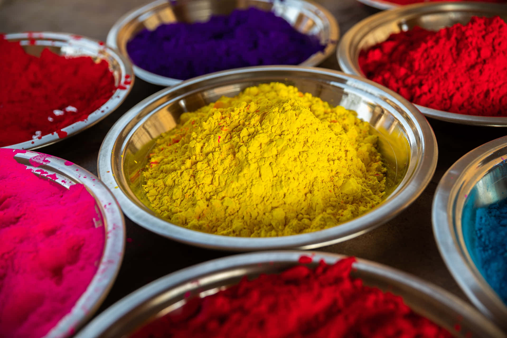 holi powder in bowls on a table