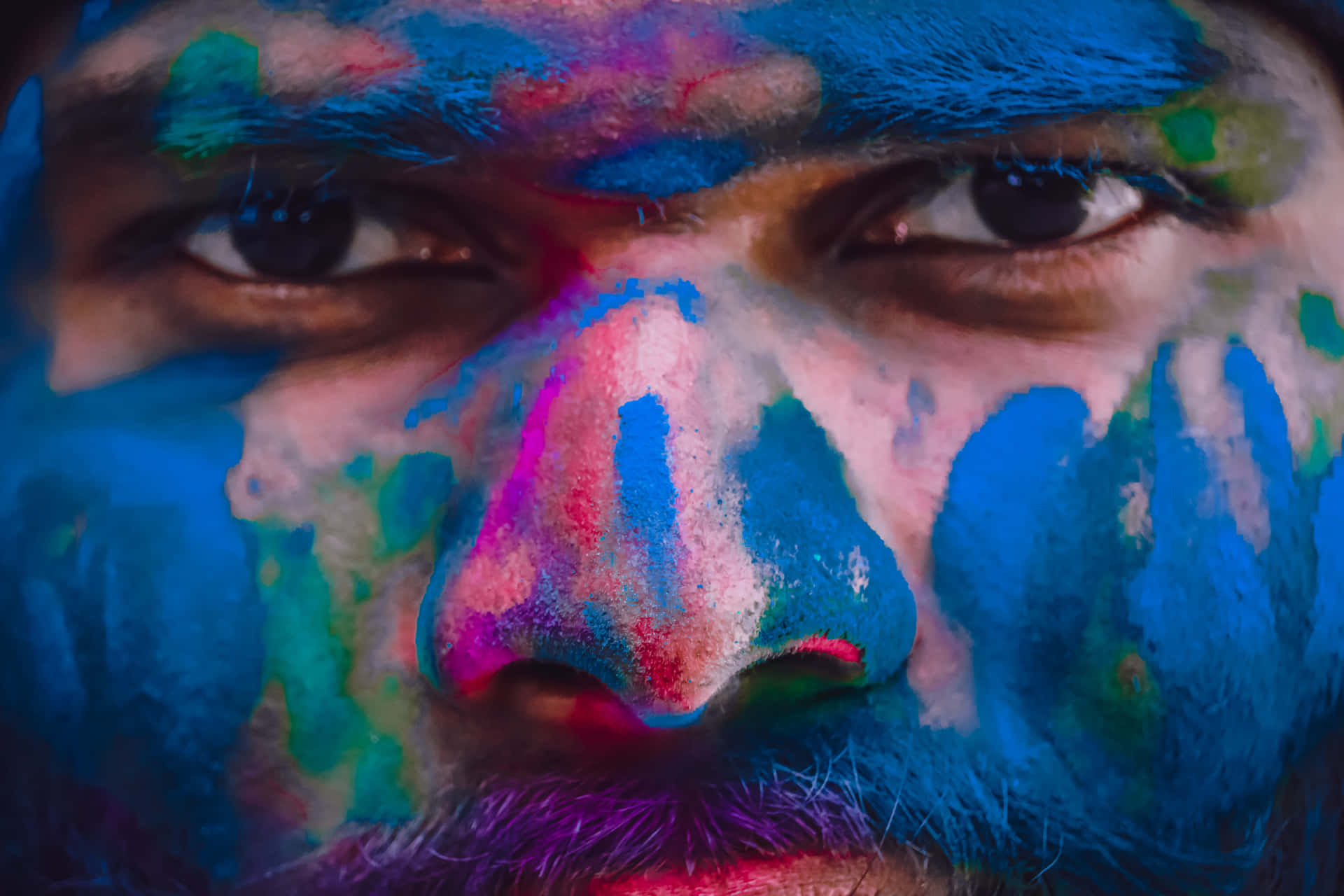 a man with colorful paint on his face
