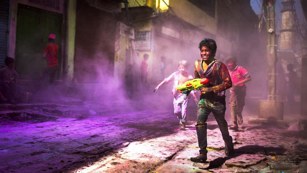 Holi Festival In A City With People Walking Through The Streets