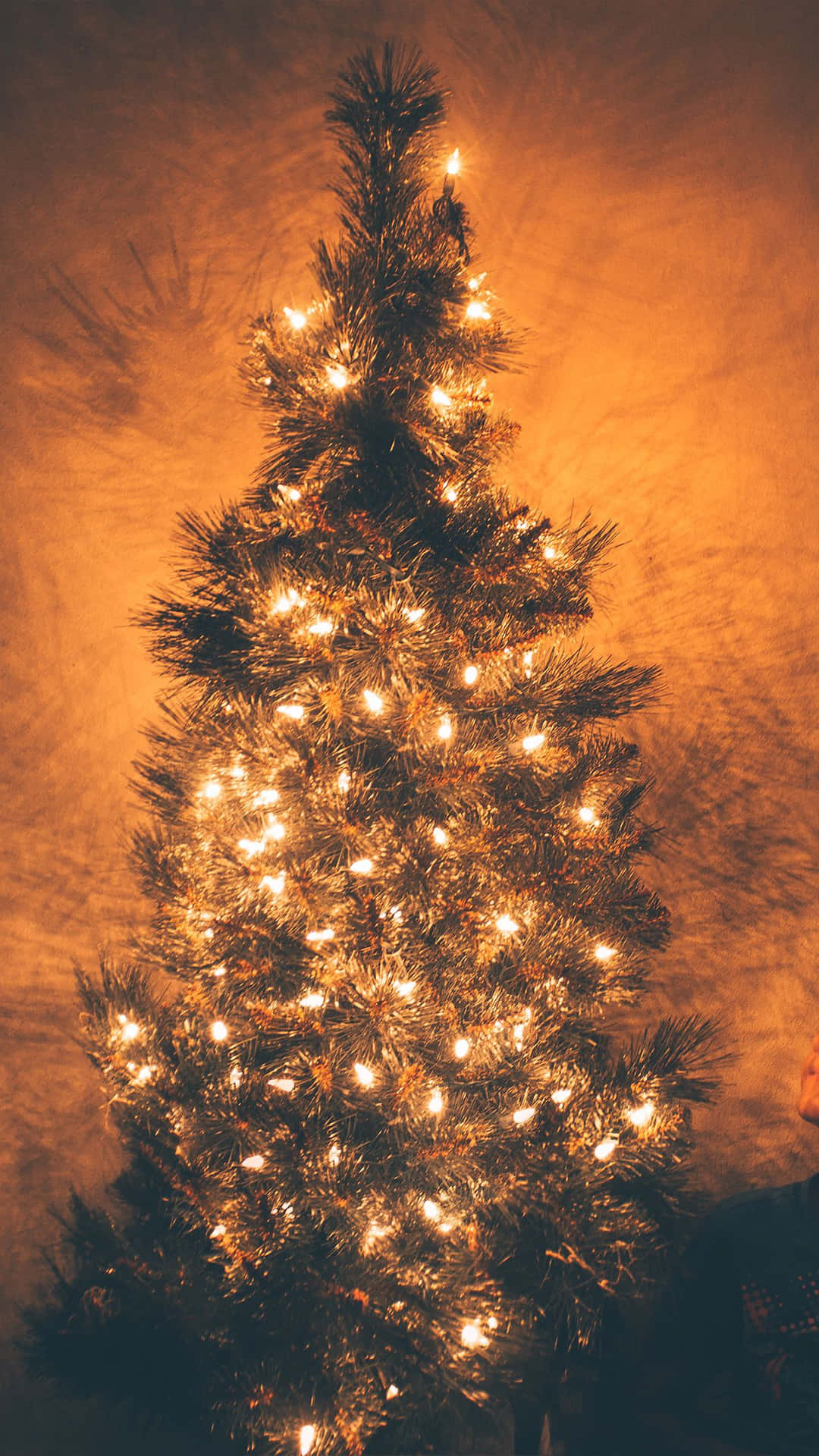A Christmas Tree With Lights In The Background Wallpaper