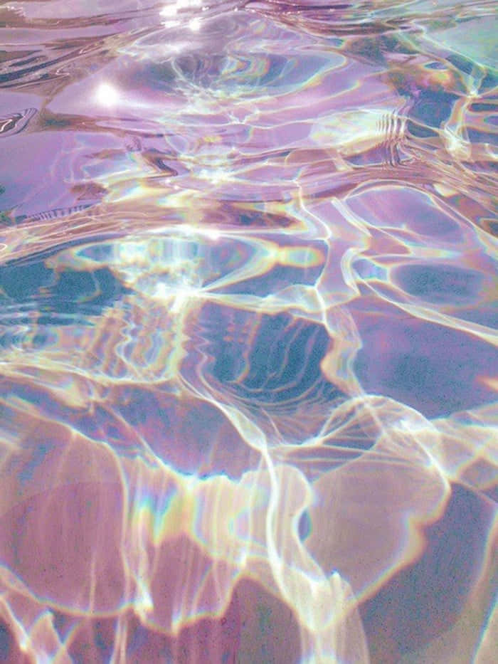 Download A Pool With A Rainbow Colored Water | Wallpapers.com