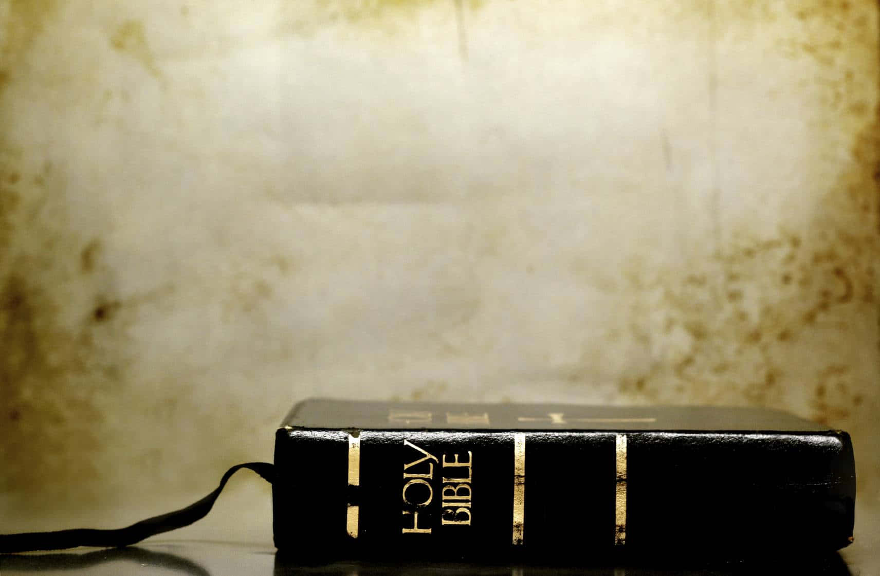 Holy Bible On Gradient Yellow Wall Wallpaper