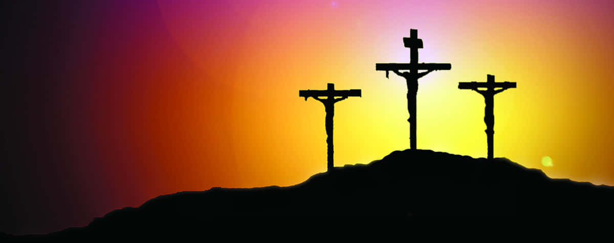 Three Crosses On A Hill With A Sunset Background Wallpaper