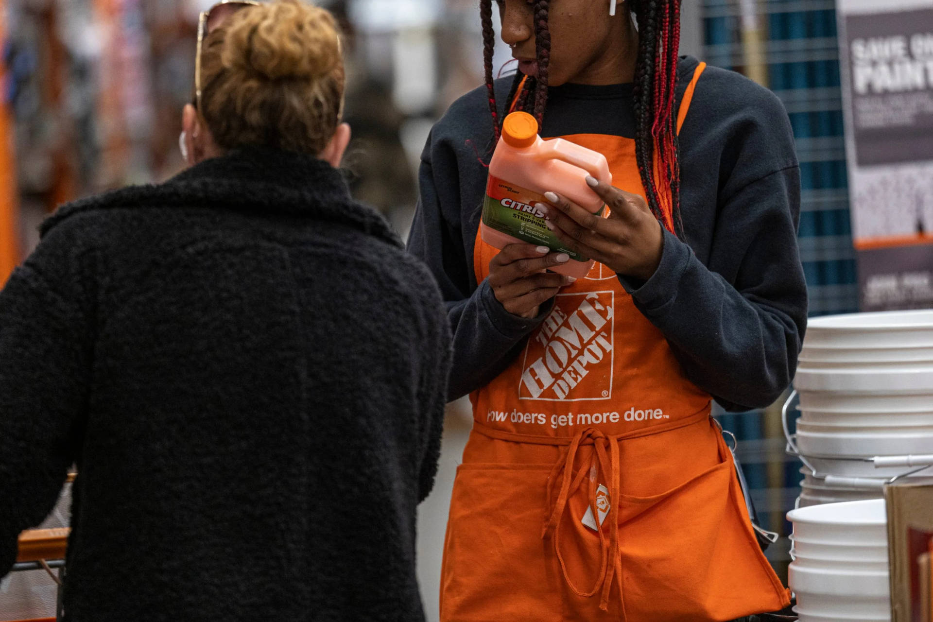 Home Depot Employee Assisting Customer in Store Wallpaper