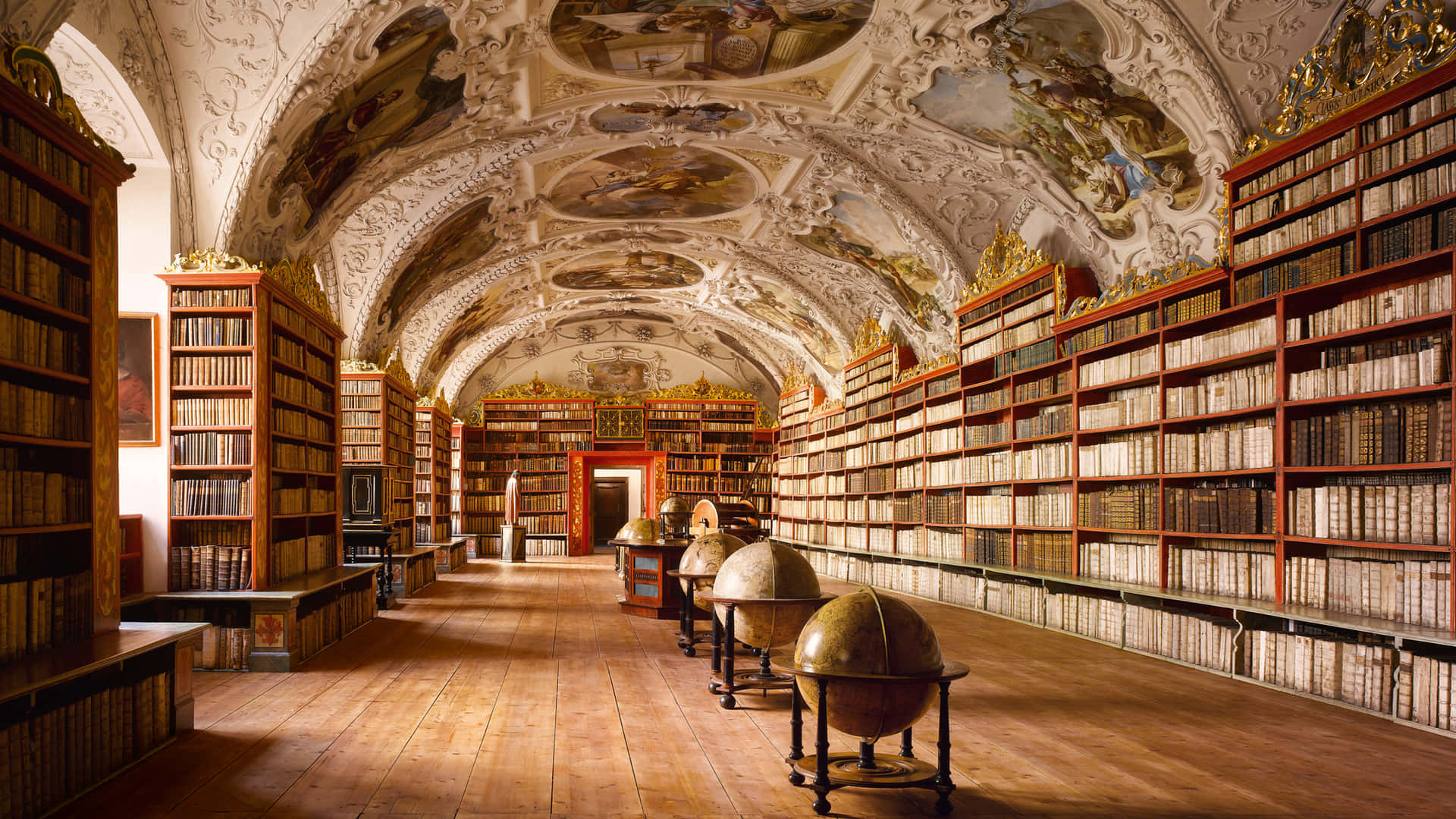 Einebibliothek Mit Vielen Bücherregalen Wallpaper