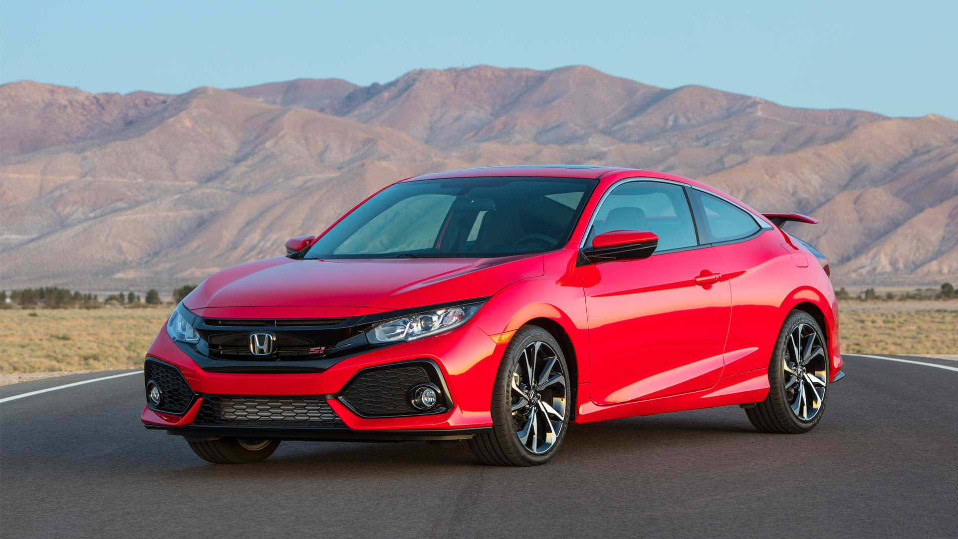 The Red 2019 Honda Civic Si Is Driving Down The Road