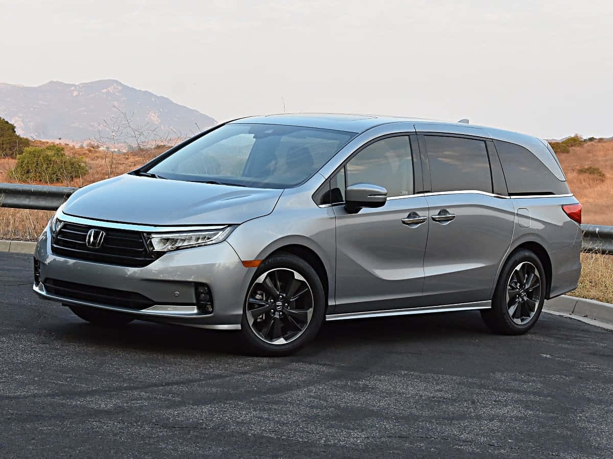 Caption: Sleek Honda Odyssey Minivan in Motion Wallpaper