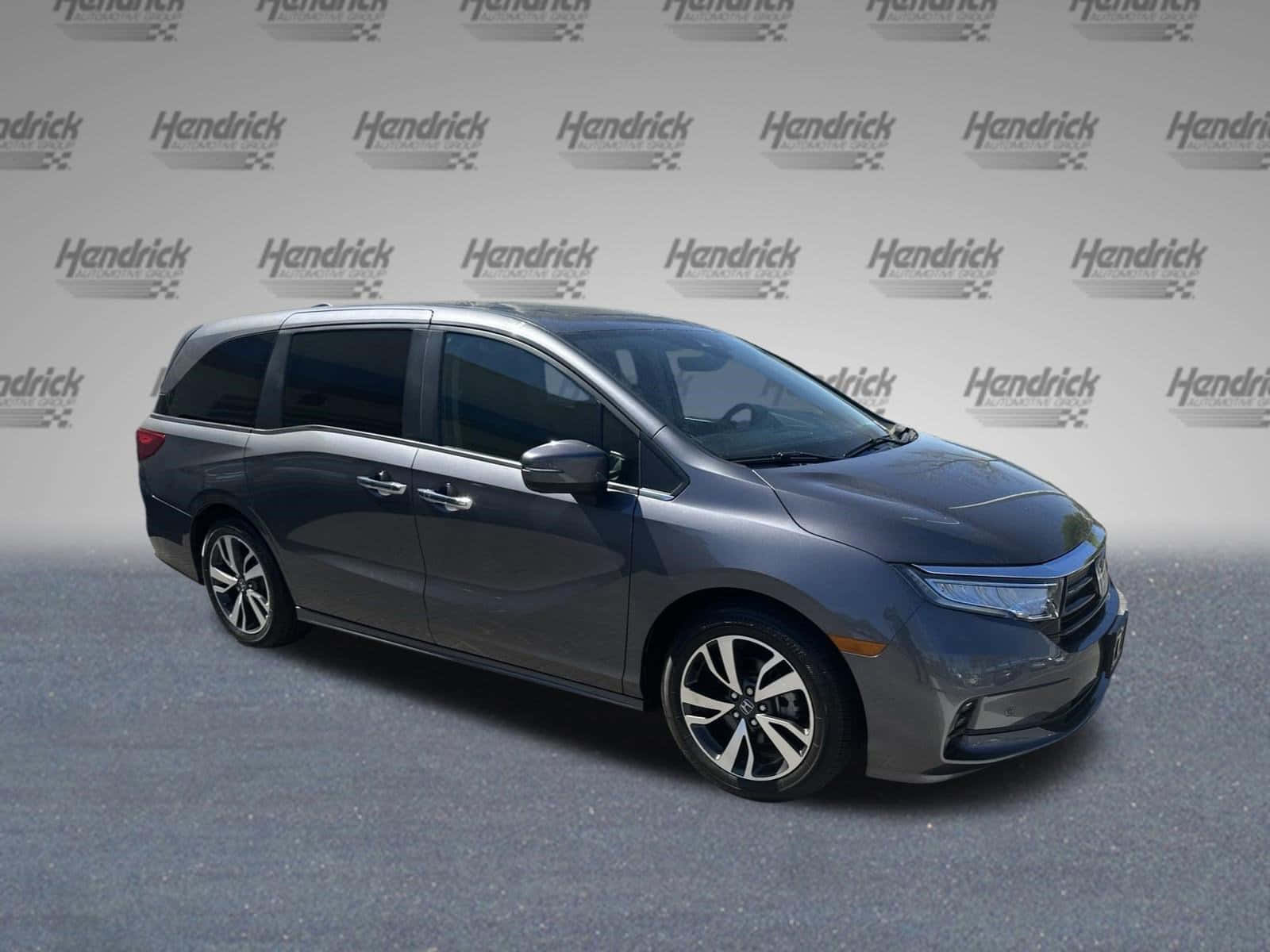 Sleek Honda Odyssey Minivan on a Scenic Highway Wallpaper