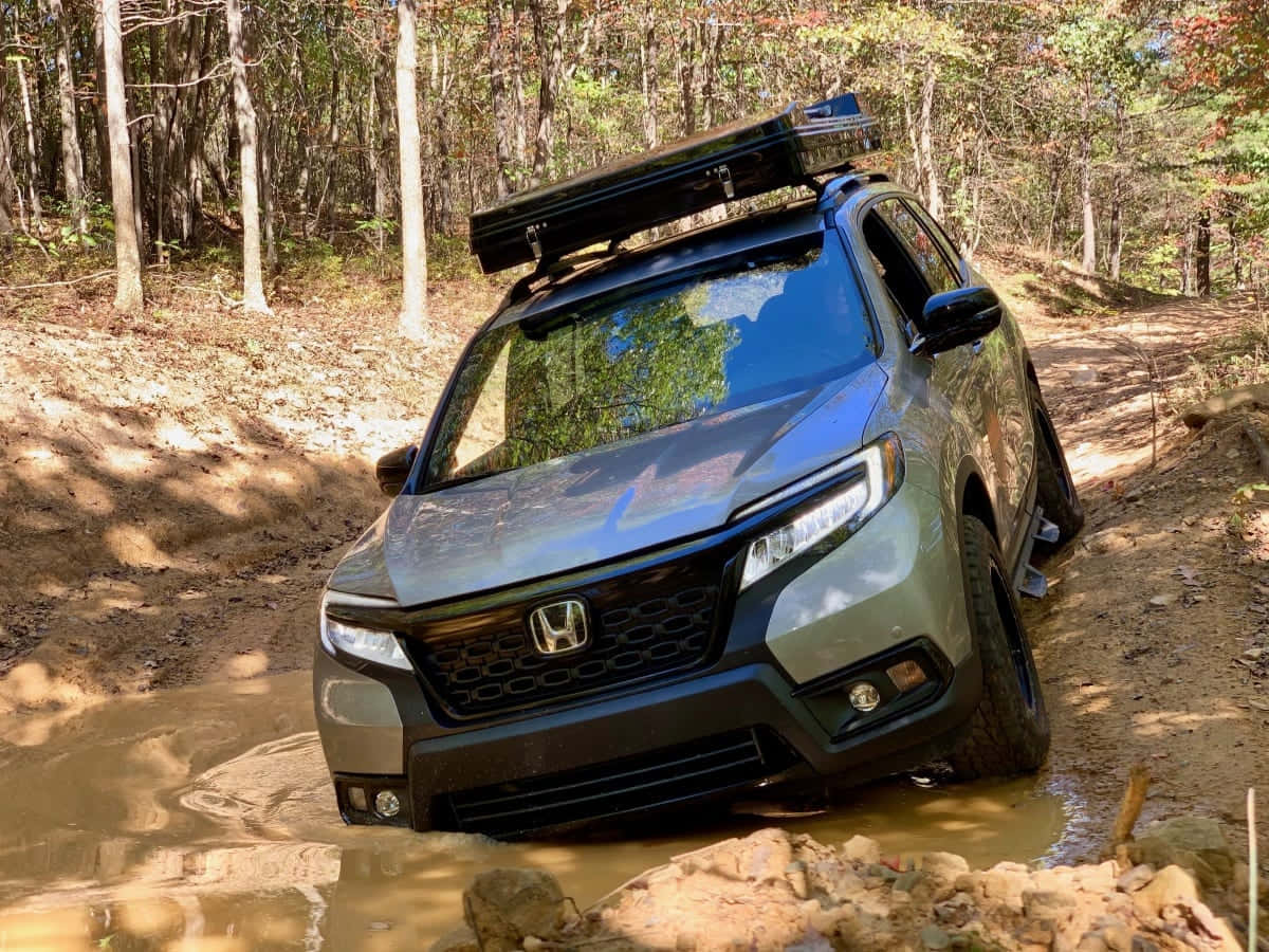 Sleek and Rugged Honda Passport Out on the Road Wallpaper