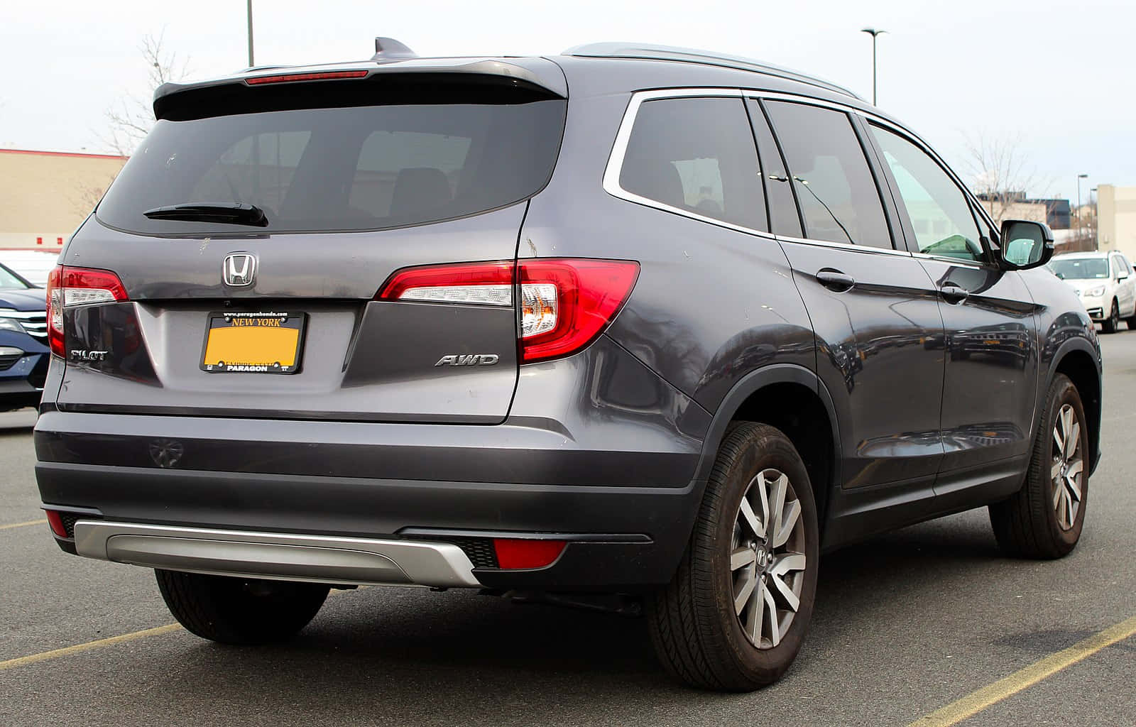 A Gray Honda Pilot Parked In A Parking Lot