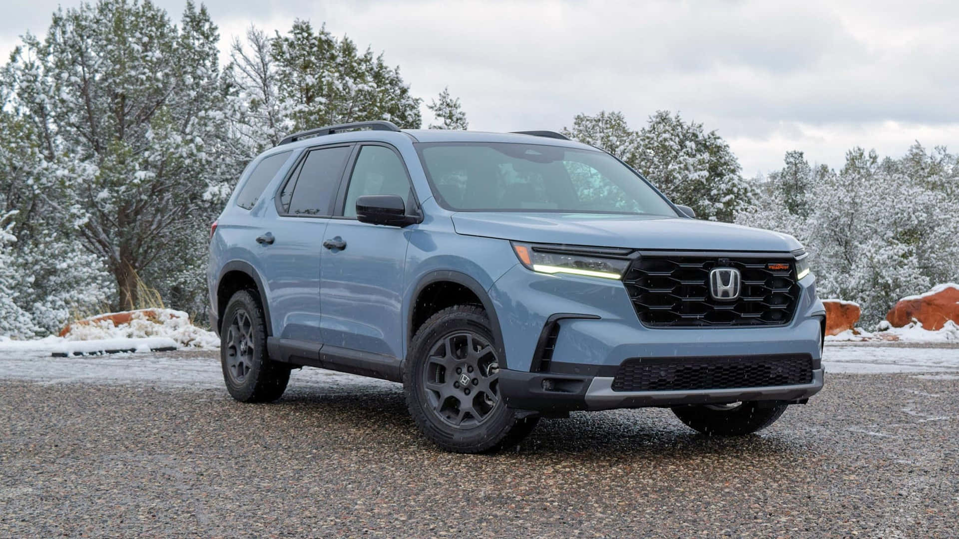 The 2019 Honda Pilot Is Parked In Front Of A Snowy Mountain