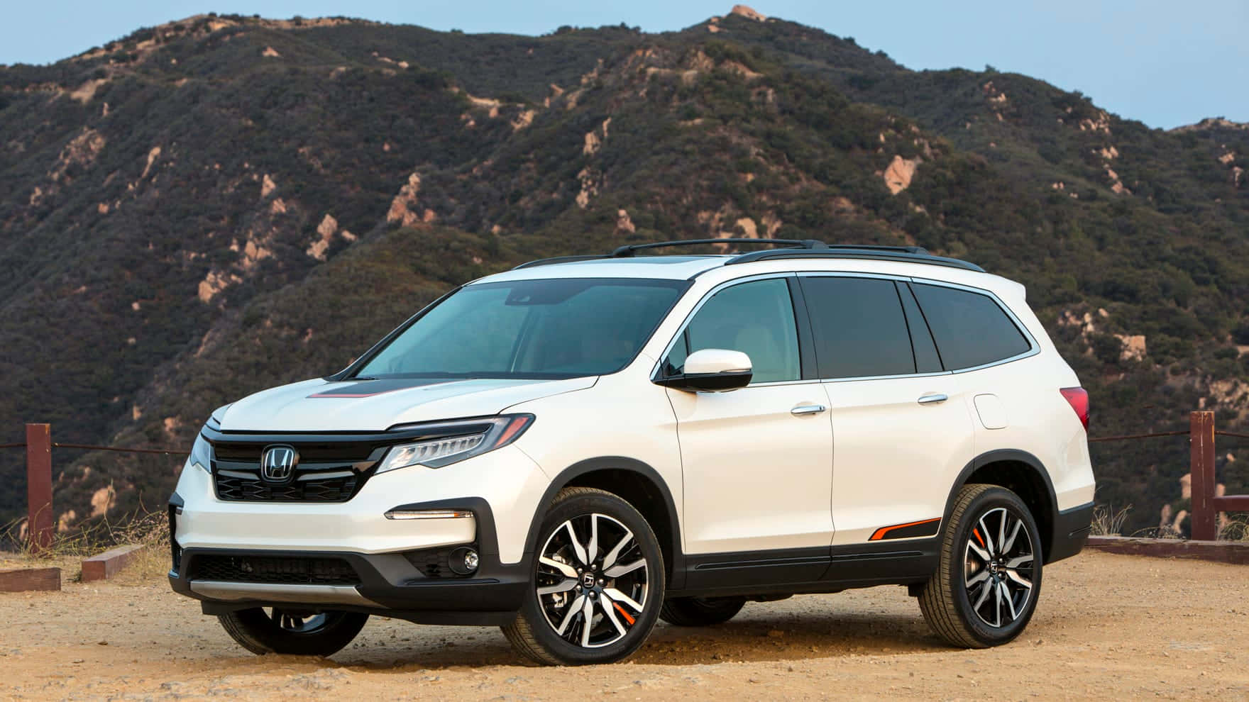 The 2019 Honda Pilot Is Parked In Front Of A Mountain