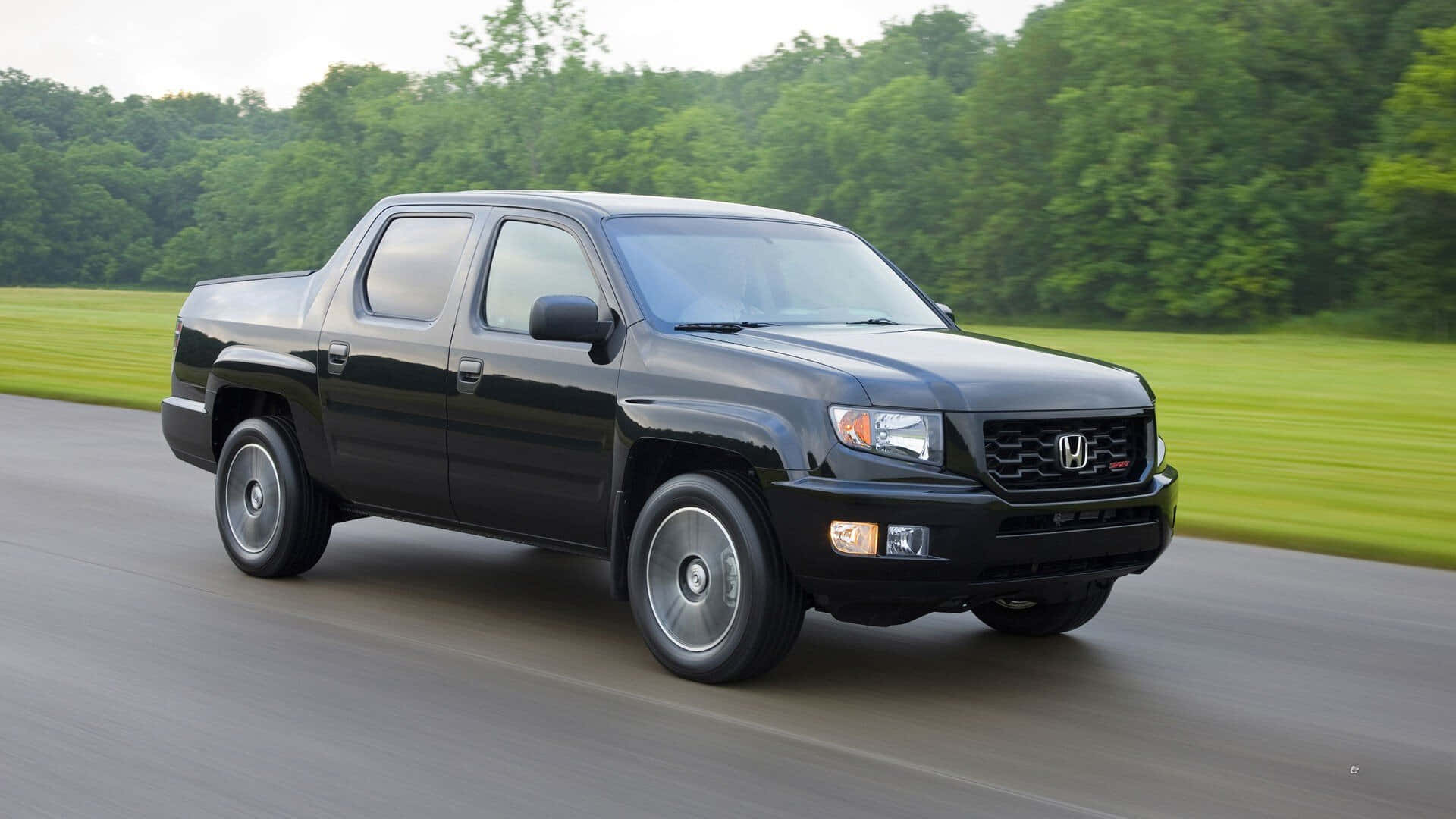 Sleek and Refined - The Honda Ridgeline on a Picturesque Drive Wallpaper
