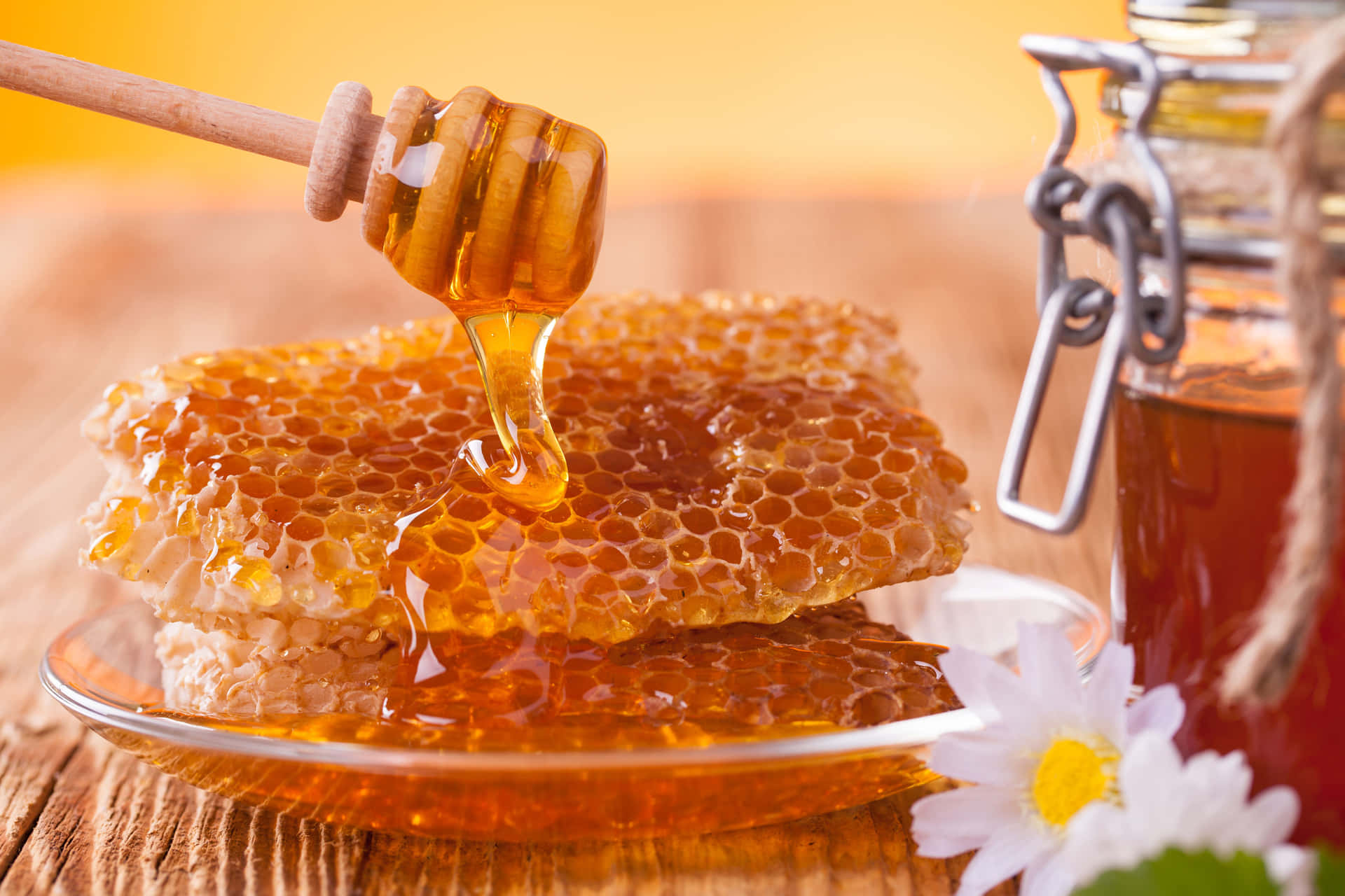 Honey Is Dripping From A Jar On A Plate