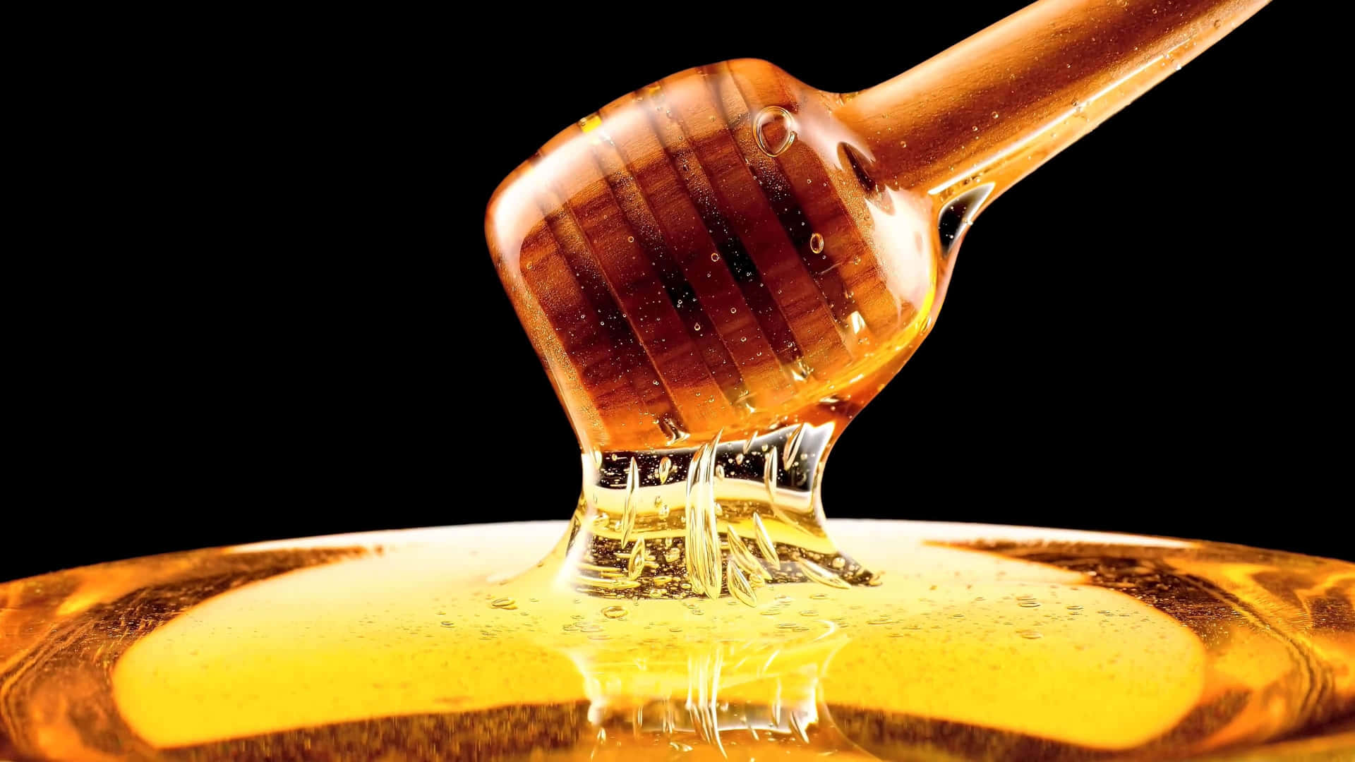 Honey Is Being Poured Into A Glass