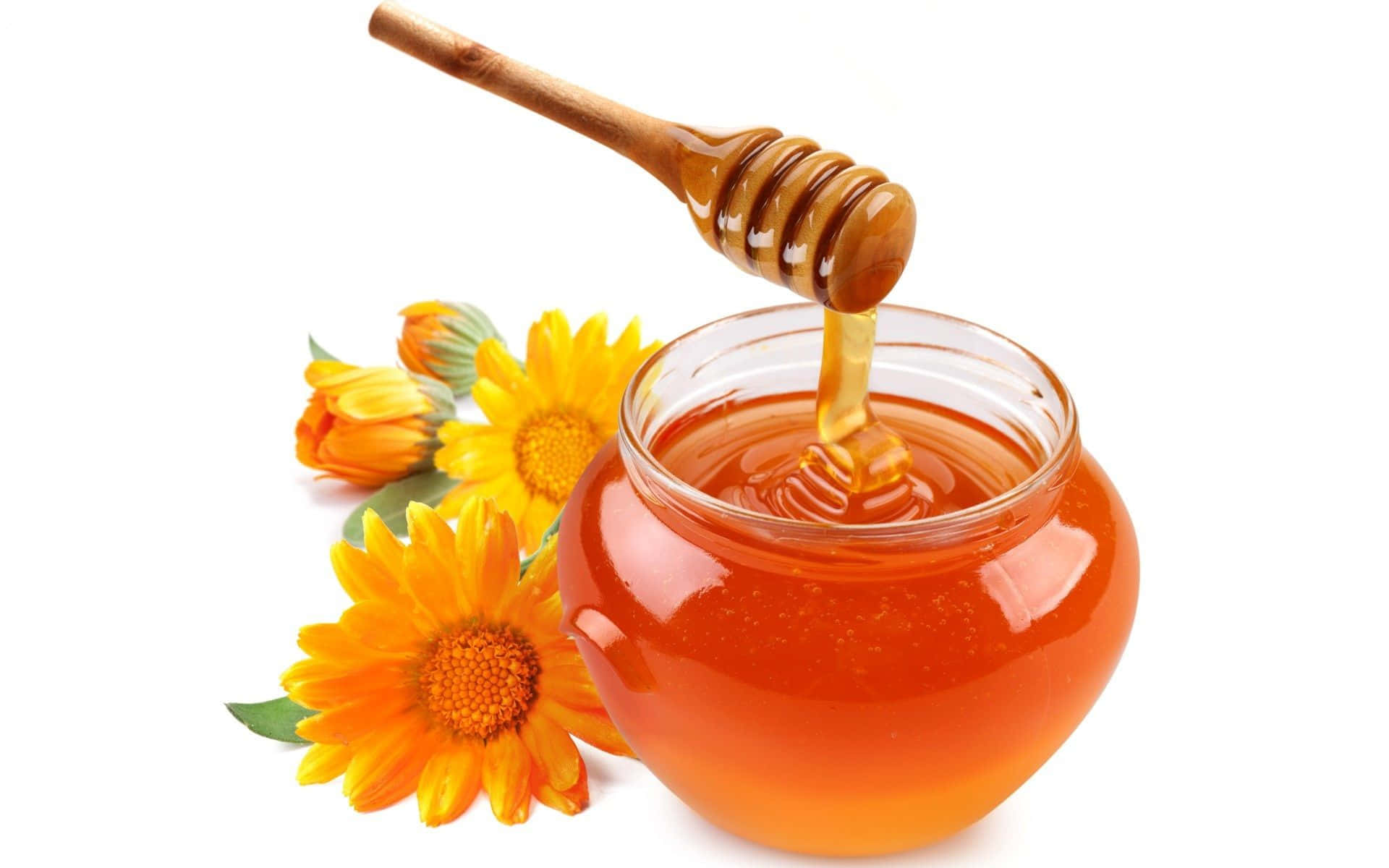 Honey Is Poured Into A Jar With Sunflowers