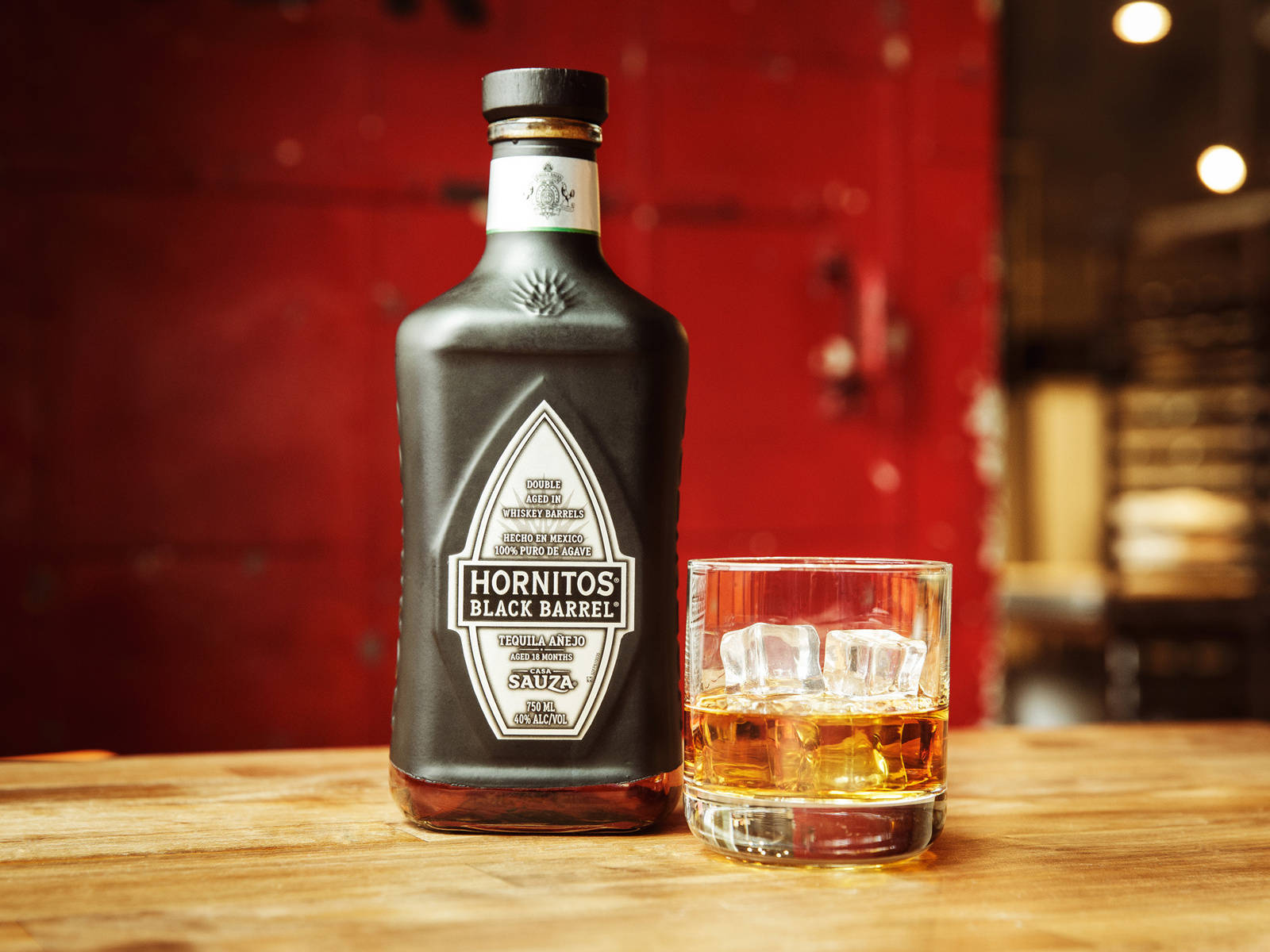Hornitos Black Barrel Tequila On Wooden Table Wallpaper