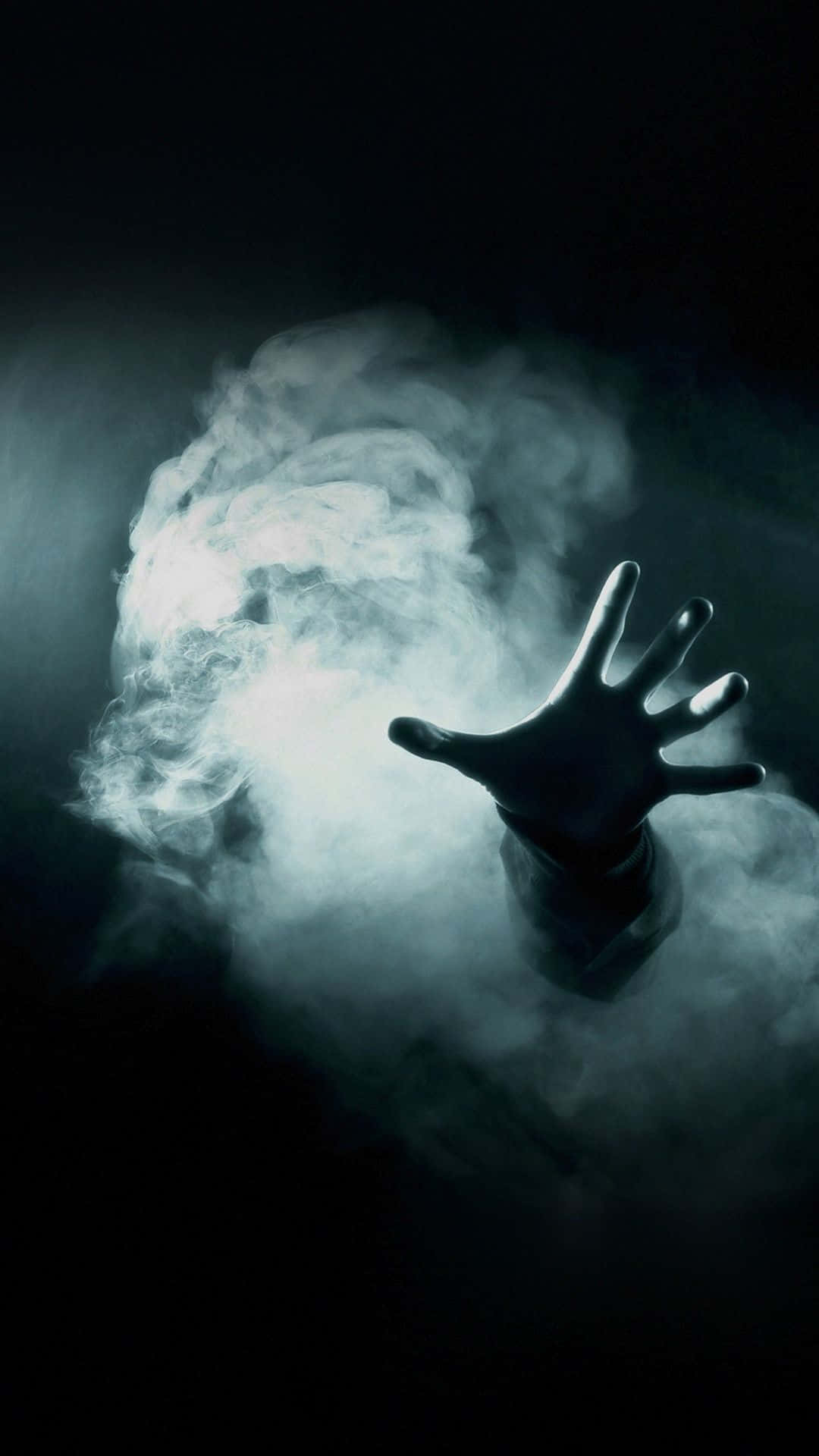 A Hand Is Reaching Out Of A Dark Room Wallpaper