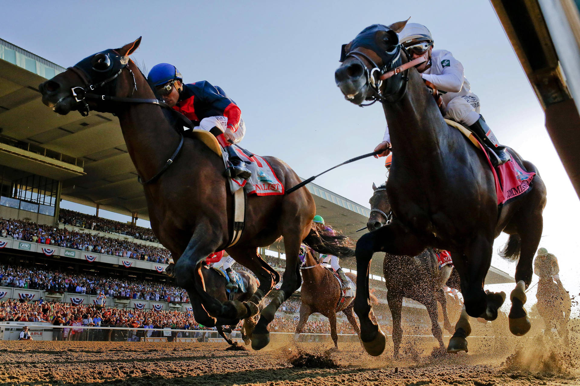 Exciting Thrill of a Horse Racing Competition Under Clear Sky Wallpaper