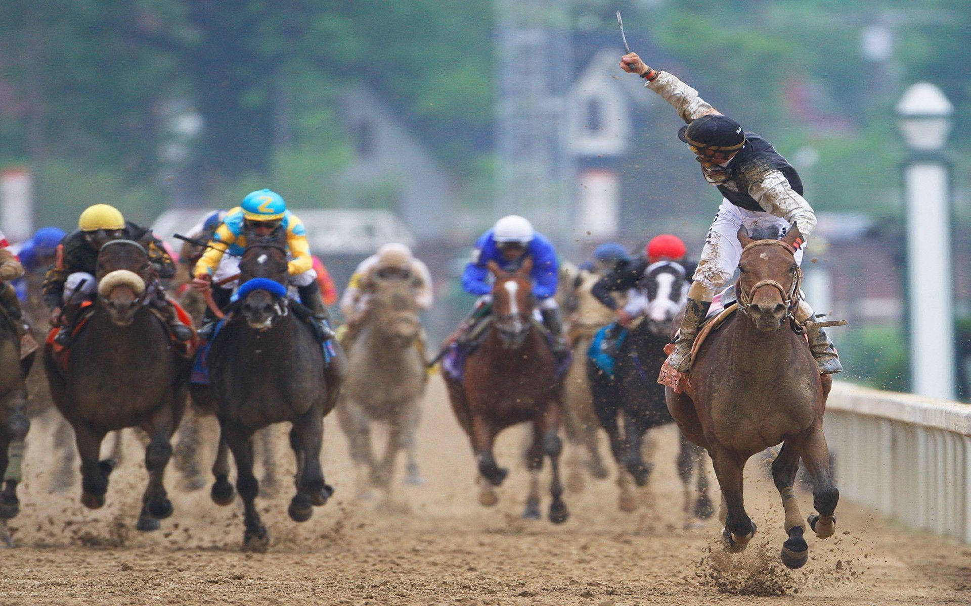 Caption: Intense Horse Racing on a Muddy Track Wallpaper