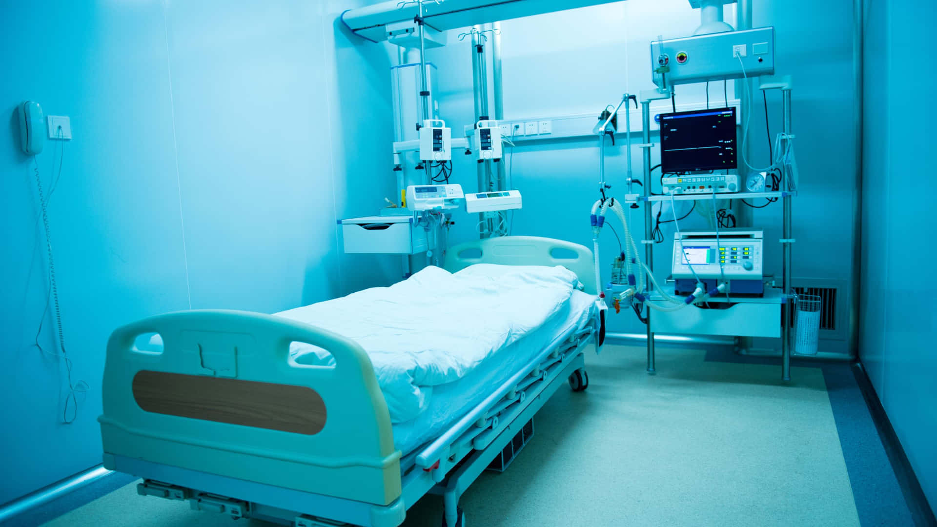 A Hospital Room With A Bed And Medical Equipment