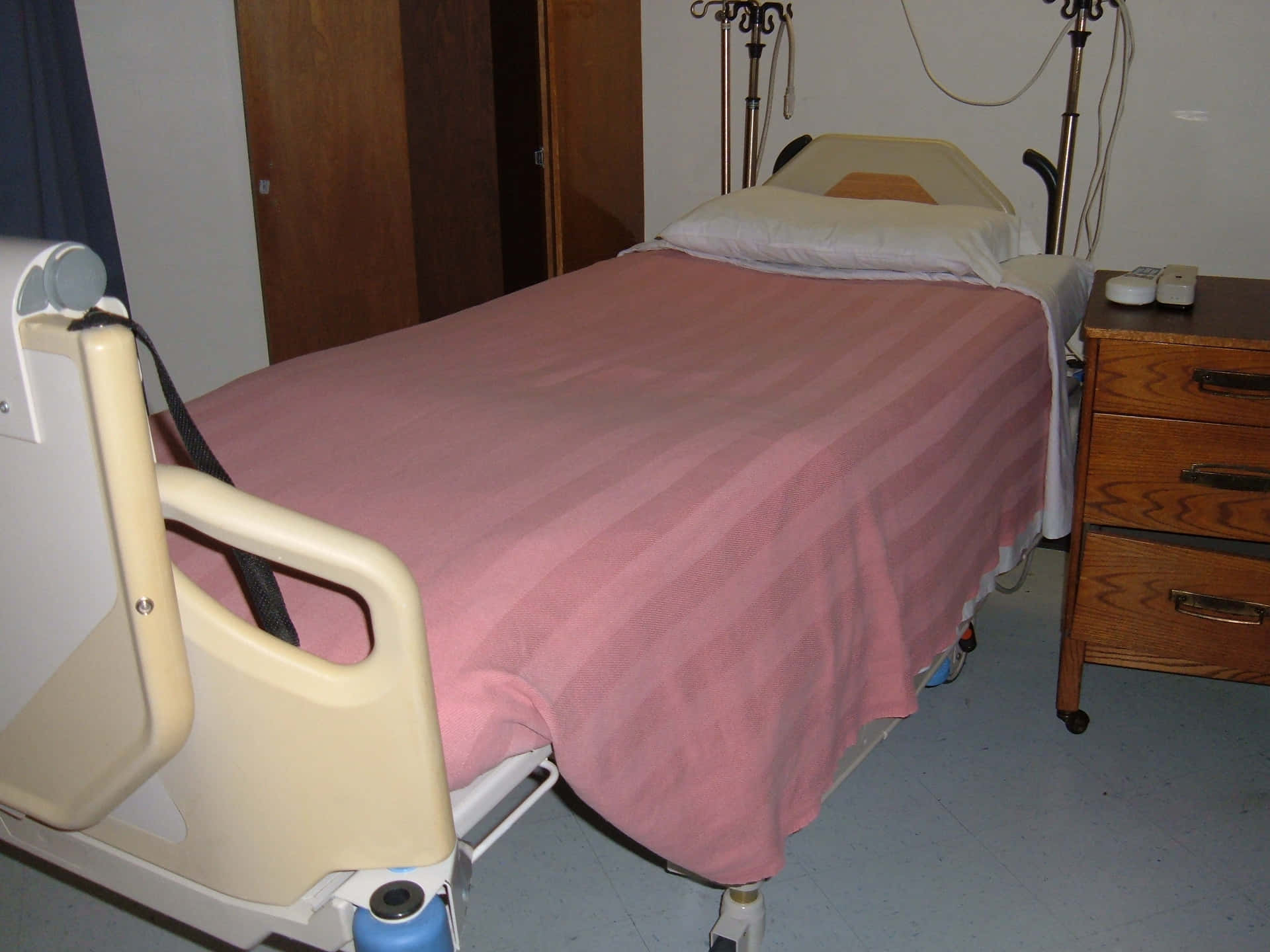 Hospital Bed With Pink Stripe Bedsheet Wallpaper