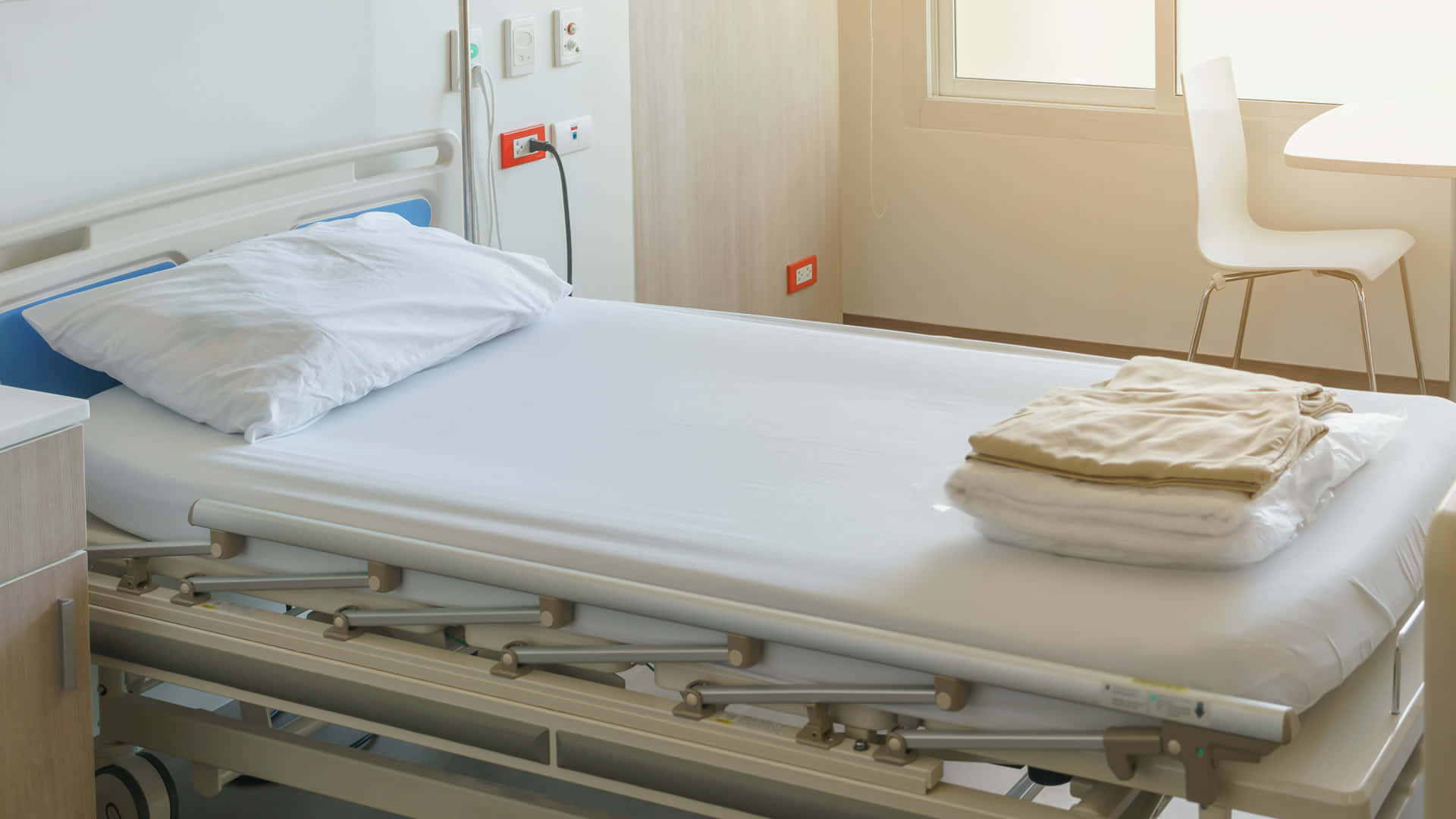 Hospital Bed With White Bedsheet Wallpaper