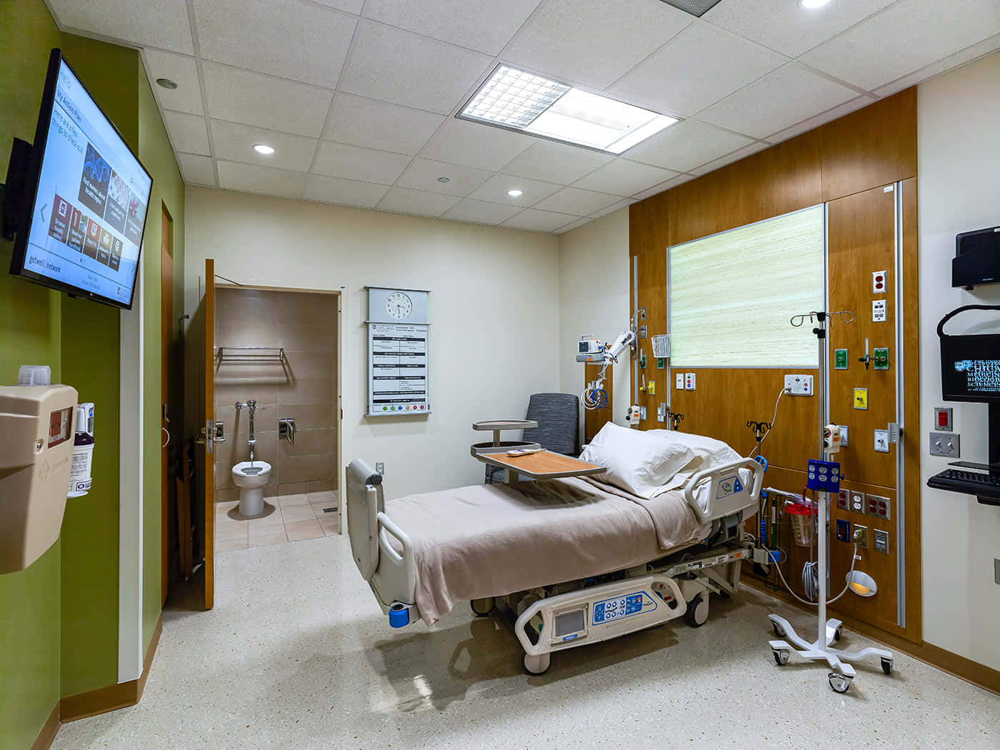 A Hospital Room With A Bed And Television