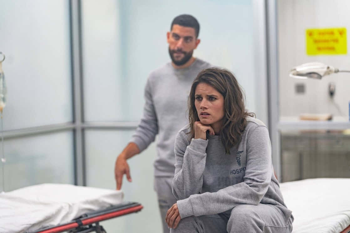 Hospital_ Scene_ Concerned_ Woman_and_ Man Wallpaper