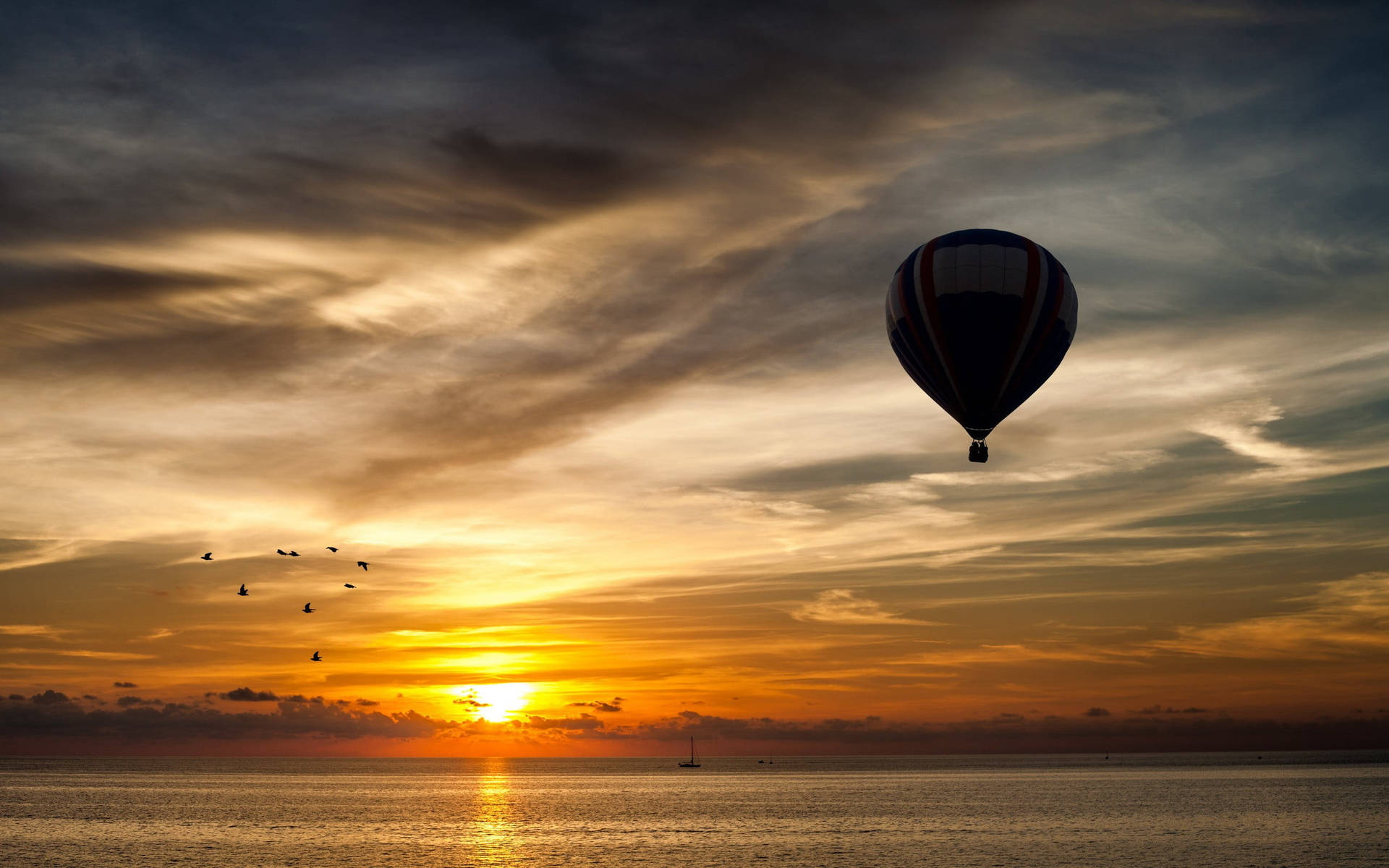 Hot Air Balloon Sunset Above Ocean Wallpaper